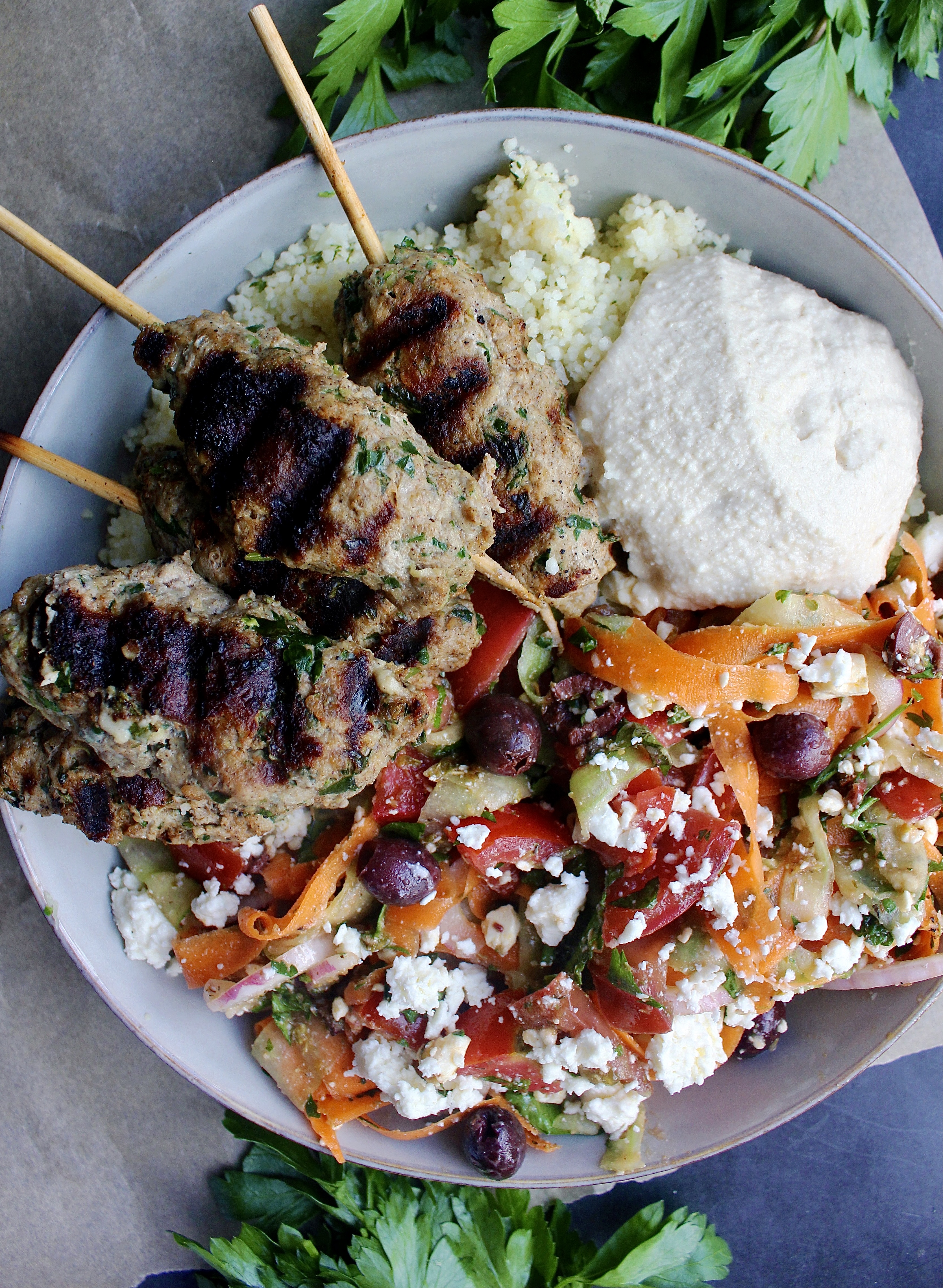 Tangy and fresh shaved greek salad with perfectly spiced grilled Chicken Kofta skewers with your favorite grains and dips: these Grilled Chicken Kofta and Shaved Greek Bowls are everyone’s favorite!