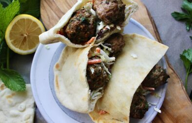 Super simple Greek Meatballs and a tangy whipped feta slaw all tucked into a warm pita: this Lemon Meatball Pitas with Tahini Feta Slaw are a crowd pleaser!!