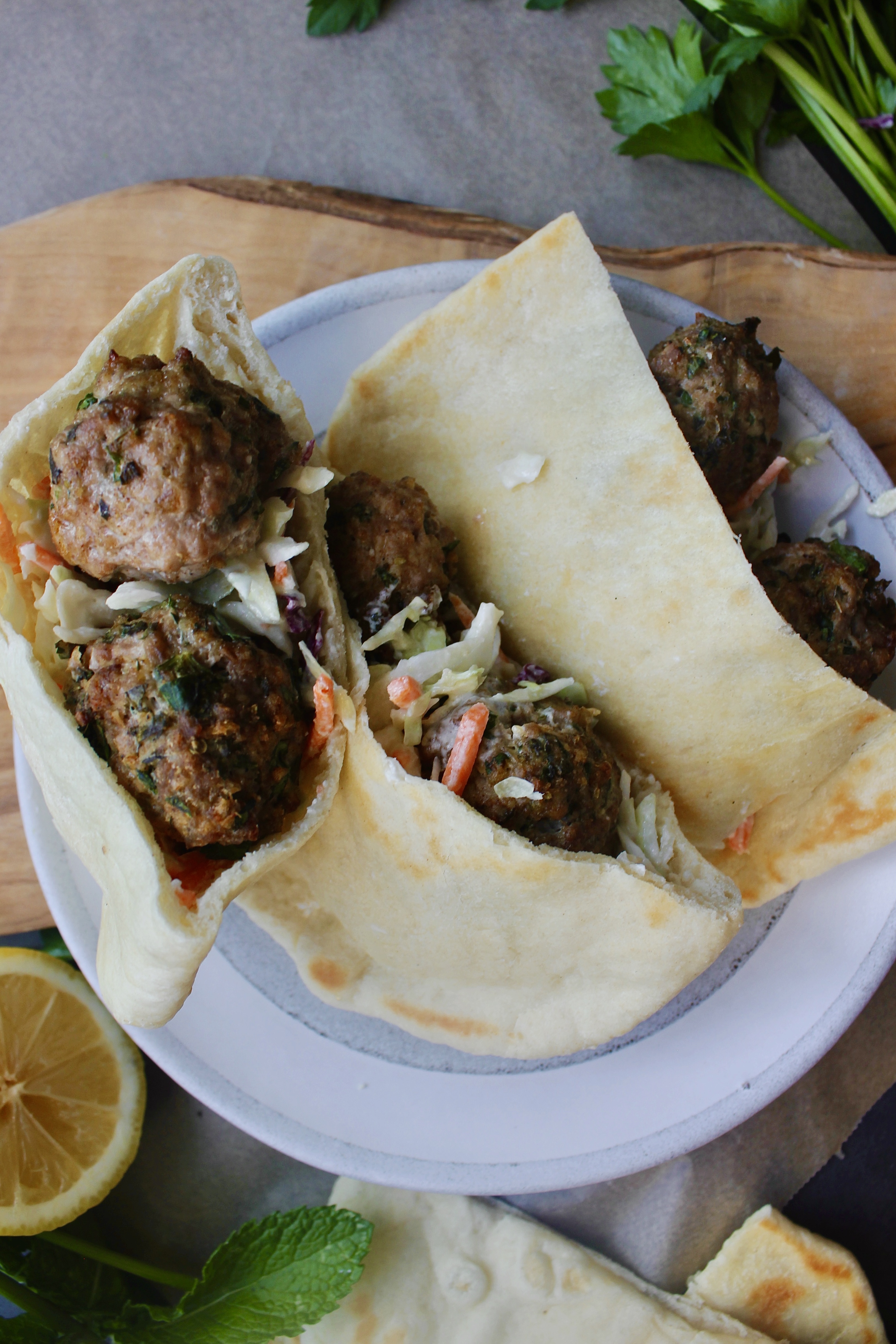 Super simple Greek Meatballs and a tangy whipped feta slaw all tucked into a warm pita: this Lemon Meatball Pitas with Tahini Feta Slaw are a crowd pleaser!!