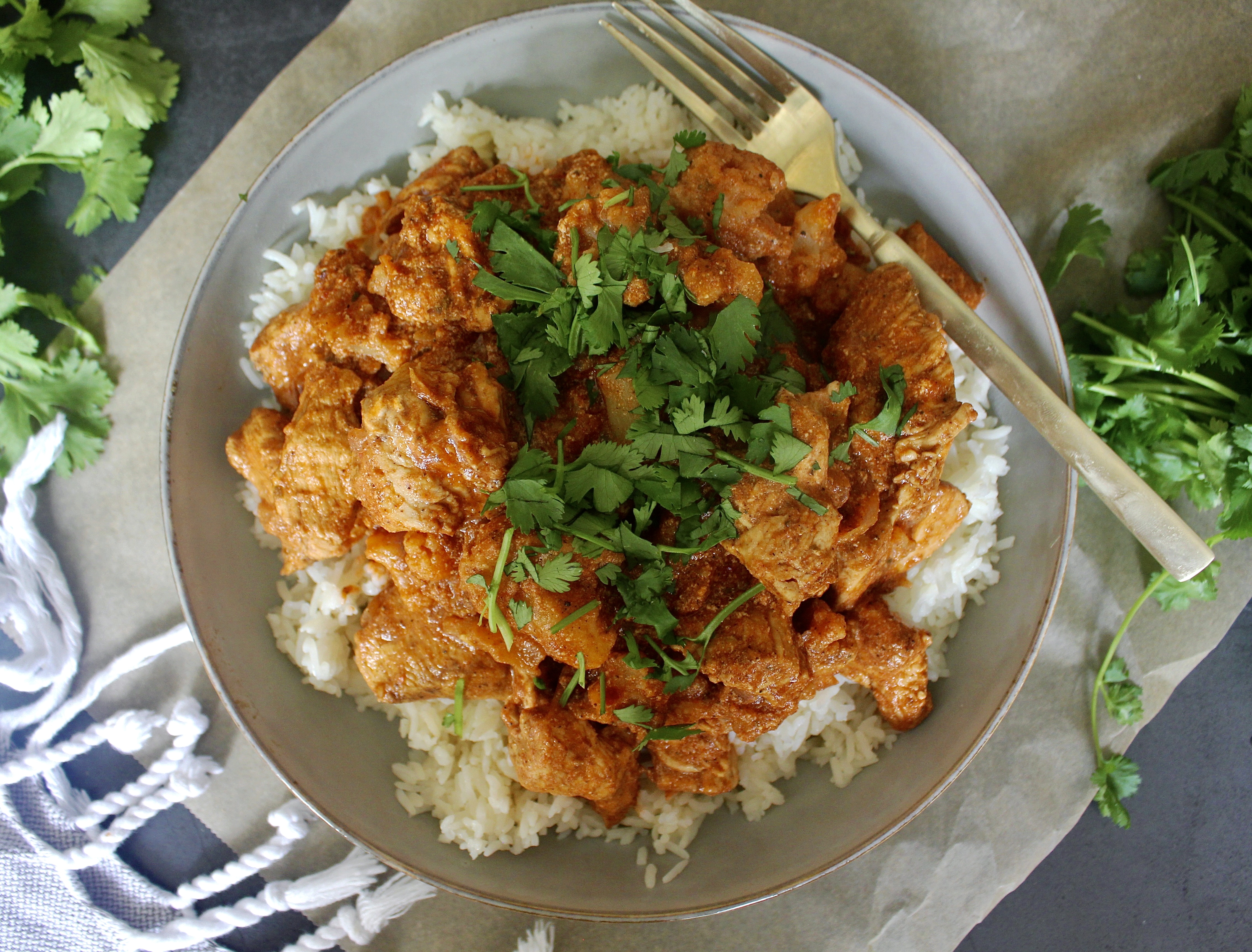 Super saucy, a tad spicy, and packed with all the cozy flavors of Indian cuisine, this Healthy Indian Spiced Chicken and Cauliflower is lightened up comfort food at its best!