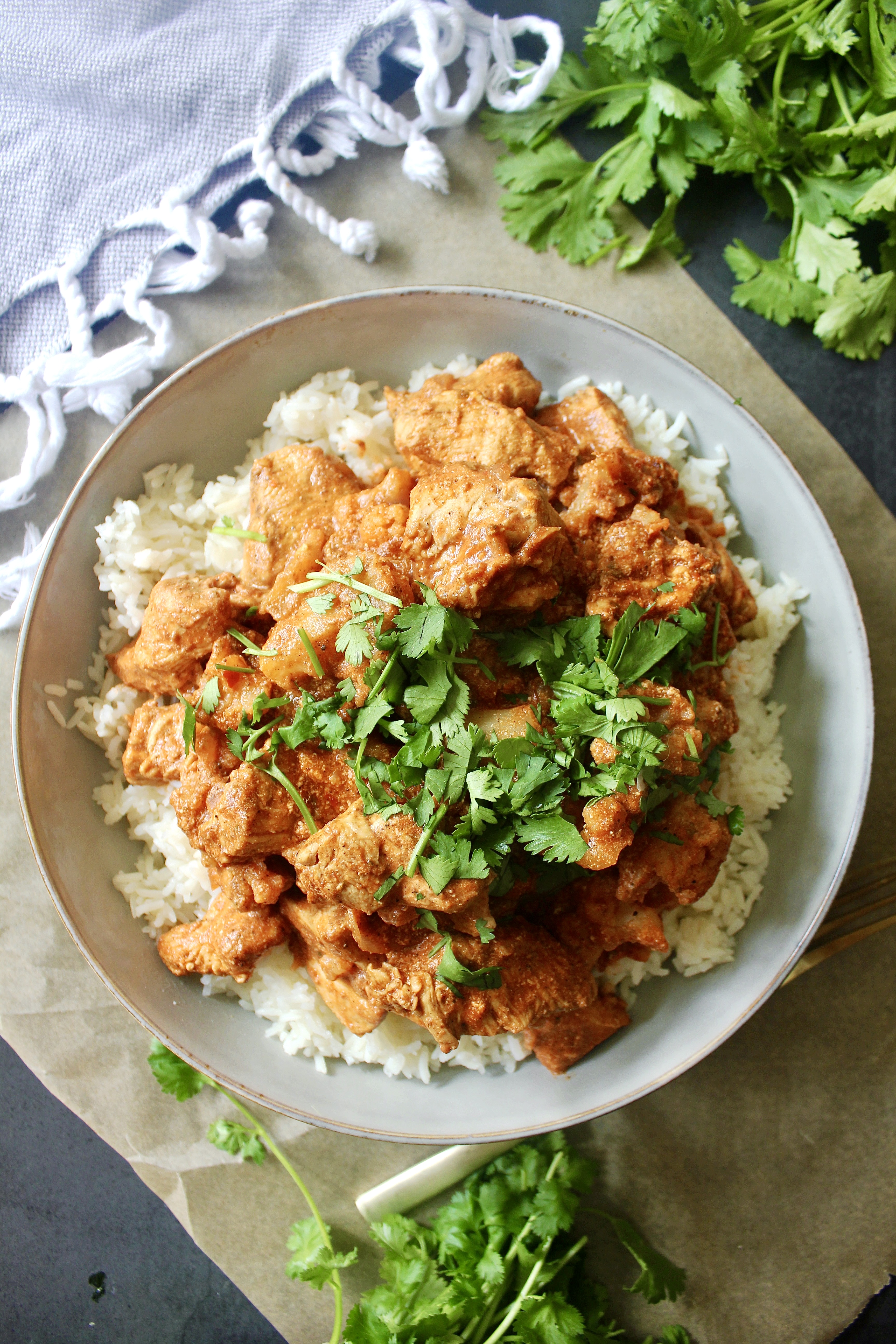 Super saucy, a tad spicy, and packed with all the cozy flavors of Indian cuisine, this Healthy Indian Spiced Chicken and Cauliflower is lightened up comfort food at its best!