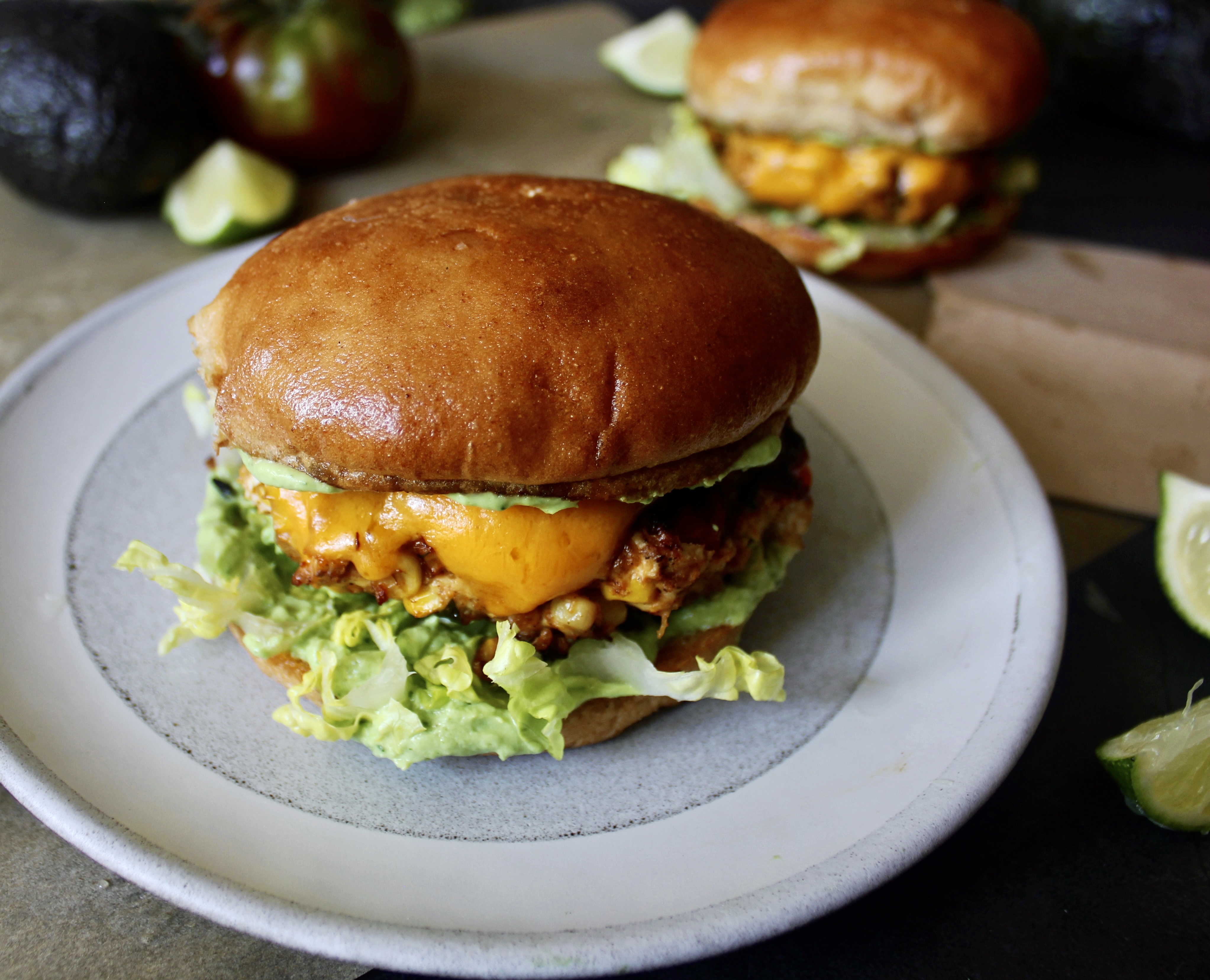 Peppers, corn, and onions sauteed in tons of spices and folded into the juiciest, chicken patties: these Fiesta Corn Cheddar Chicken Burgers with Avocado Sauce are next level amazing. 