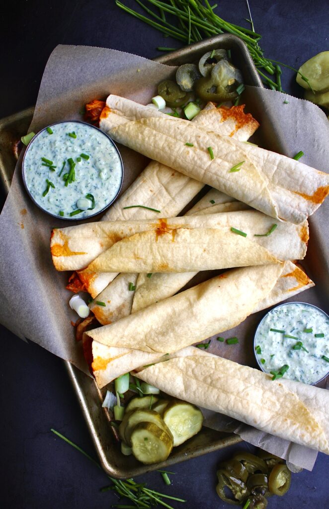  Sweet and spicy barbecue pulled chicken with caramelized onions and tons of spices all tucked into a warm, crisp oven baked tortilla: these Barbecue Chicken Taquitos with Herbed Crema are heavenly.