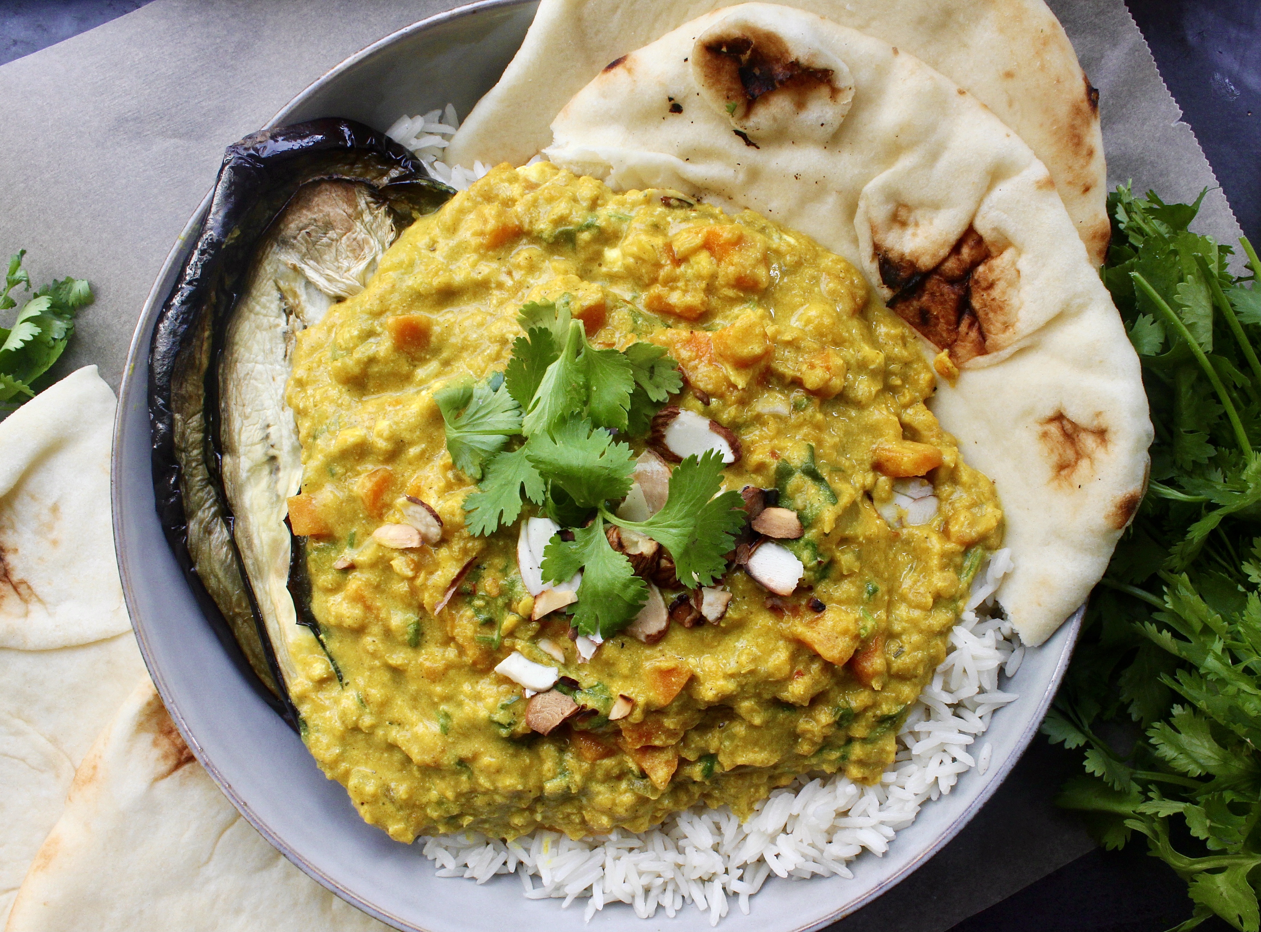 Smooth, spiced, and extra saucy lentils spooned over perfectly roasted eggplant: these Creamy Curried Lentils with Roasted Eggplant are the ultimate healthy comfort food.