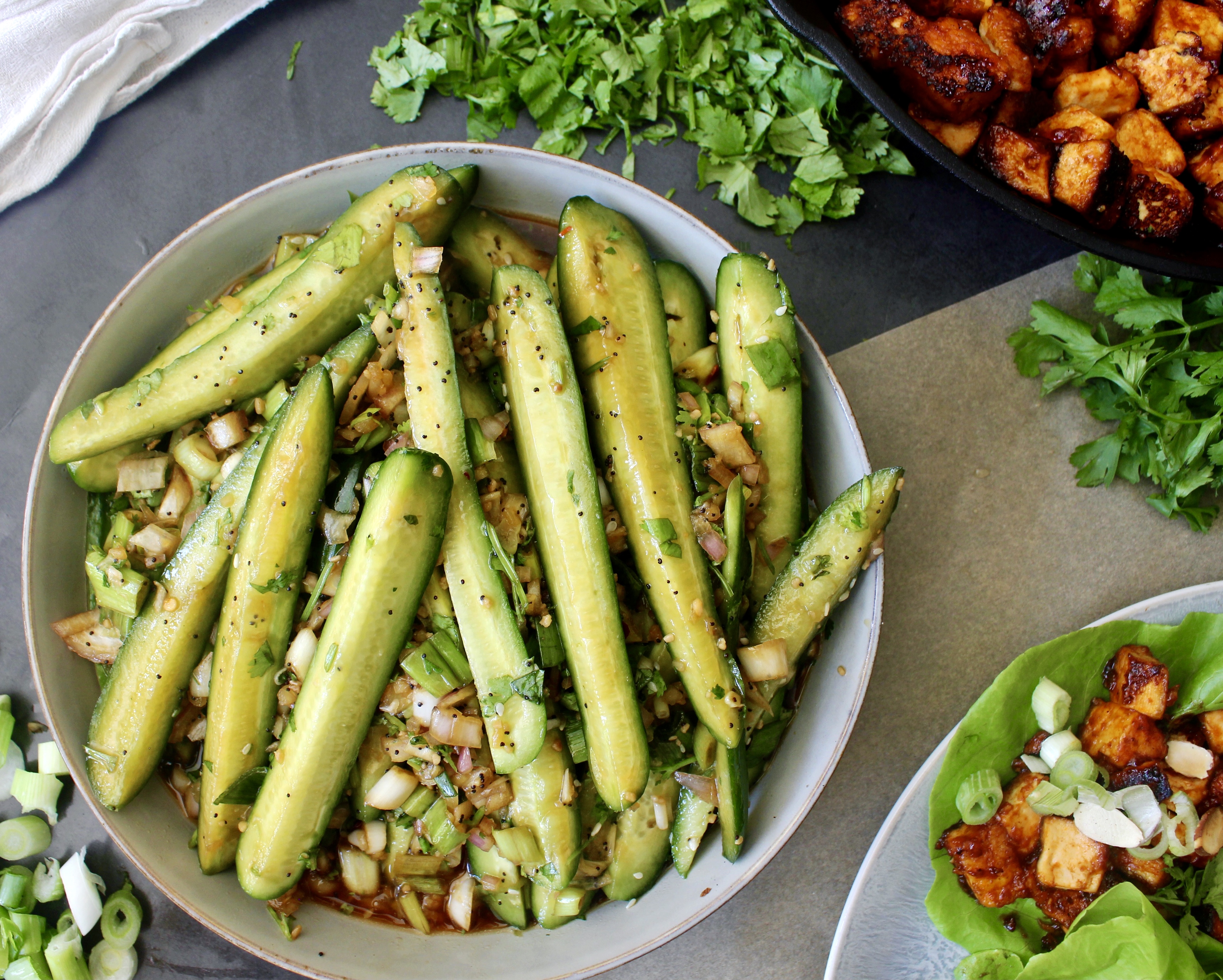 Crunchy persian cucumbers, shallots, and scallions marinated tossed with a simple sweet and tangy Asian vinaigrette with crispy sesame seeds: this Marinated Asian Cucumber Scallion Salad truly hits all the marks!