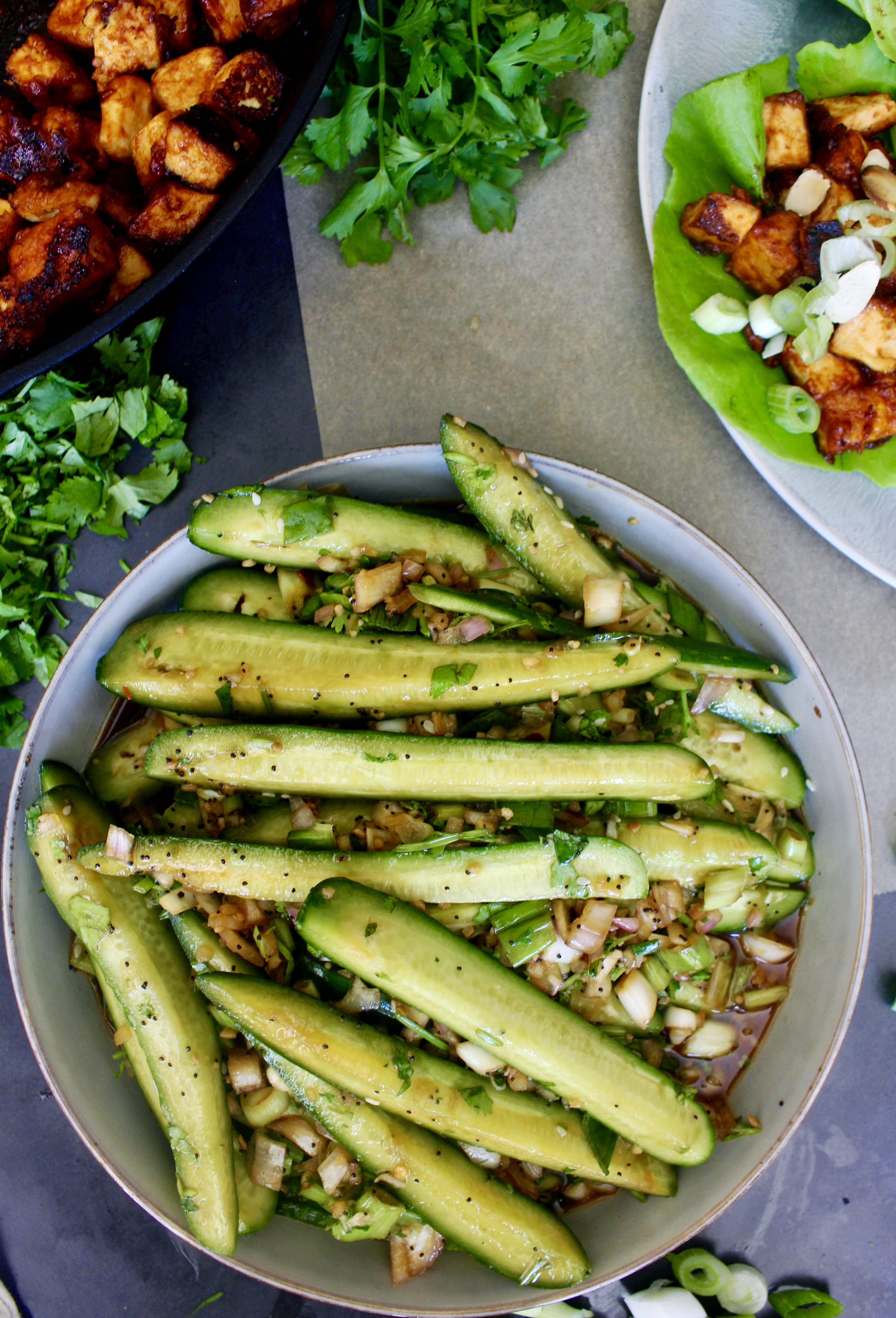 Crunchy persian cucumbers, shallots, and scallions marinated tossed with a simple sweet and tangy Asian vinaigrette with crispy sesame seeds: this Marinated Asian Cucumber Scallion Salad truly hits all the marks!