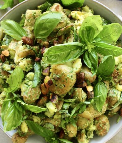 Crispy smashed baby potatoes tossed in a simple arugula pesto: This Smashed Pistachio Pesto di Rucola Potato Salad is the best summer mayo-free potato salad!