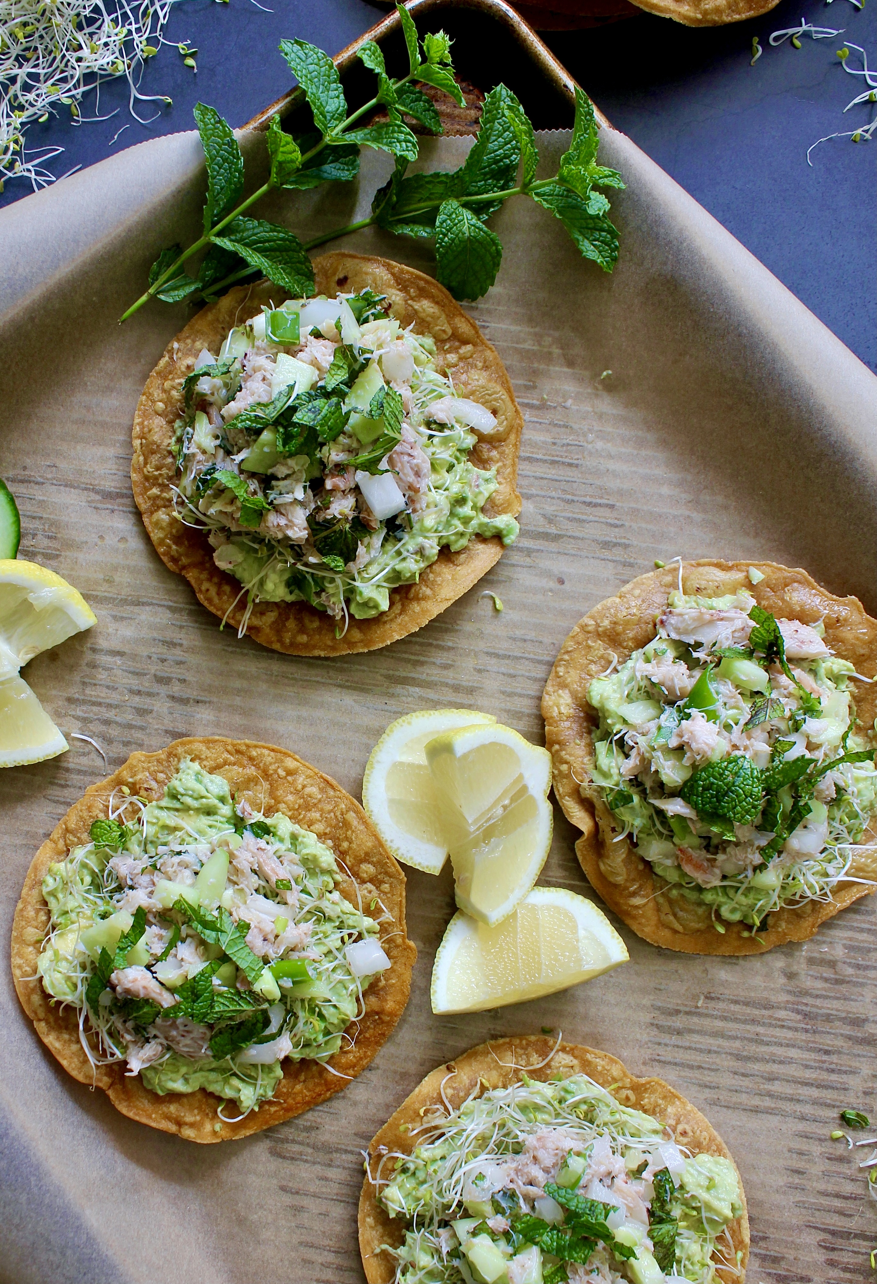 Creamy tangy jumbo lump crab slaw, avocado, and greens layered over a crispy oven baked tostada shell: these Cucumber Avocado Crab Slaw Tostadas are one of my favorite ways to eat crab.