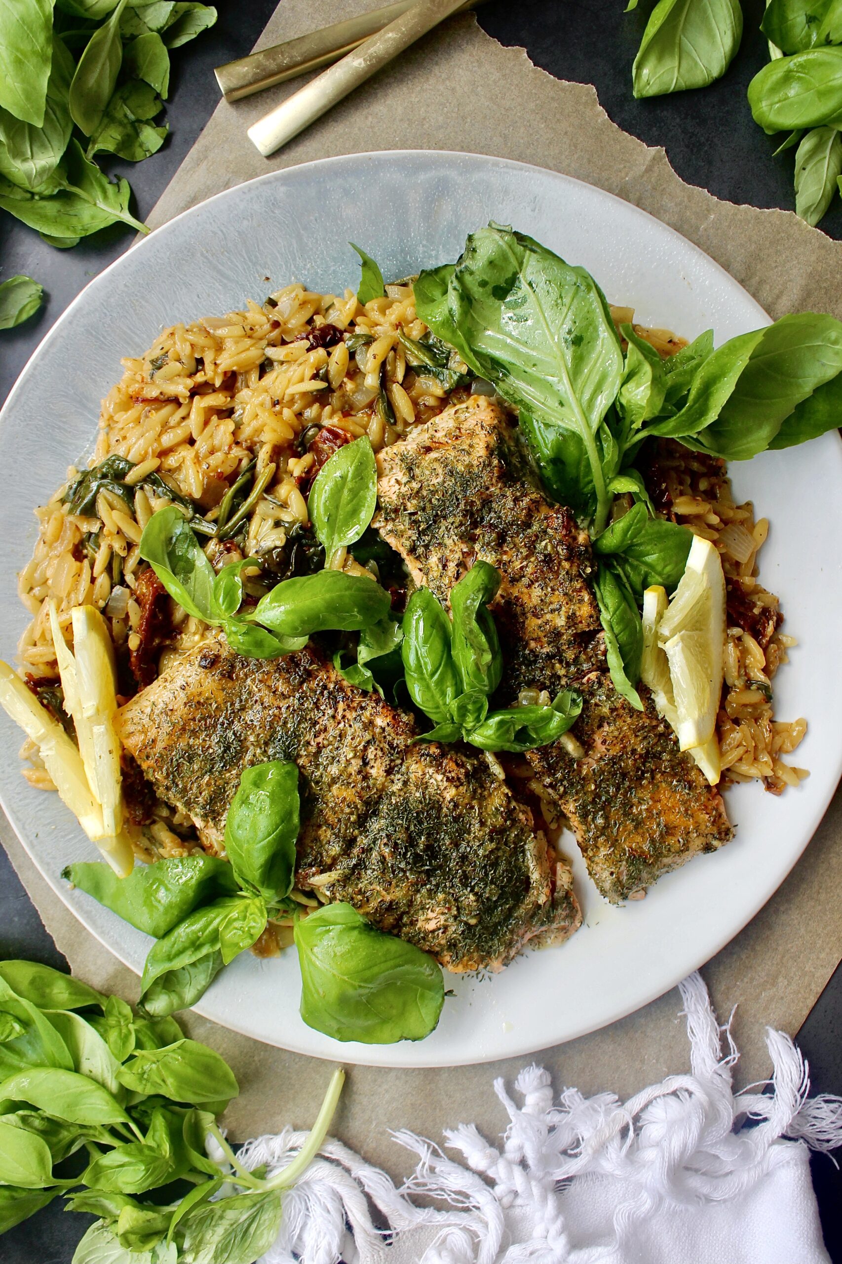 Crispy seared salmon tucked into orzo cooked in rosé, sun dried tomatoes, and herbs: this Herbed Salmon and Orzo with Sun-Dried Tomatoes is truly the best one-pot meal.