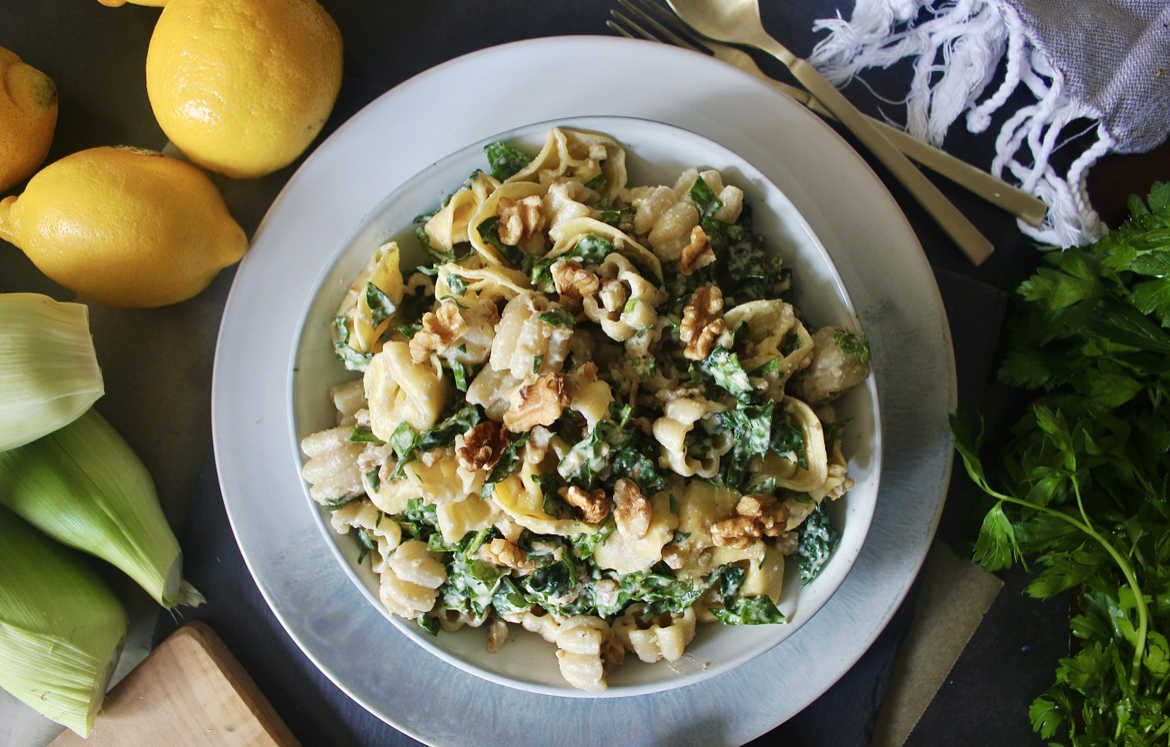 A creamy crunchy walnut parmesan dressing massaged into kale and tossed with chilled cheese tortellini: this Parmesan Kale Tortellini Pasta Salad makes for the best summer side!!