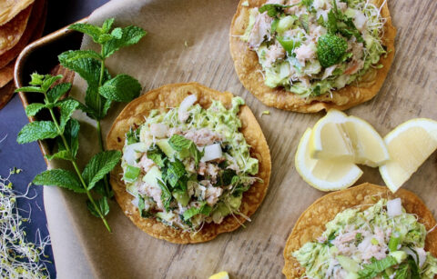 Creamy tangy jumbo lump crab slaw, avocado, and greens layered over a crispy oven baked tostada shell: these Cucumber Avocado Crab Slaw Tostadas are one of my favorite ways to eat crab.