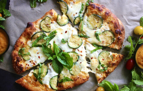 Fresh mozzarella and pecorino melted over a homemade yellow tomato sauce and finished off with crispy summer zucchini: this Pecorino Crusted Yellow Pizza with Crispy Zucchini is truly the best summer pizza.