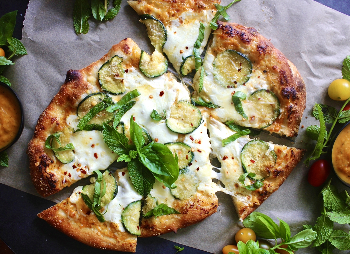 Fresh mozzarella and pecorino melted over a homemade yellow tomato sauce and finished off with crispy summer zucchini: this Pecorino Crusted Yellow Pizza with Crispy Zucchini is truly the best summer pizza.