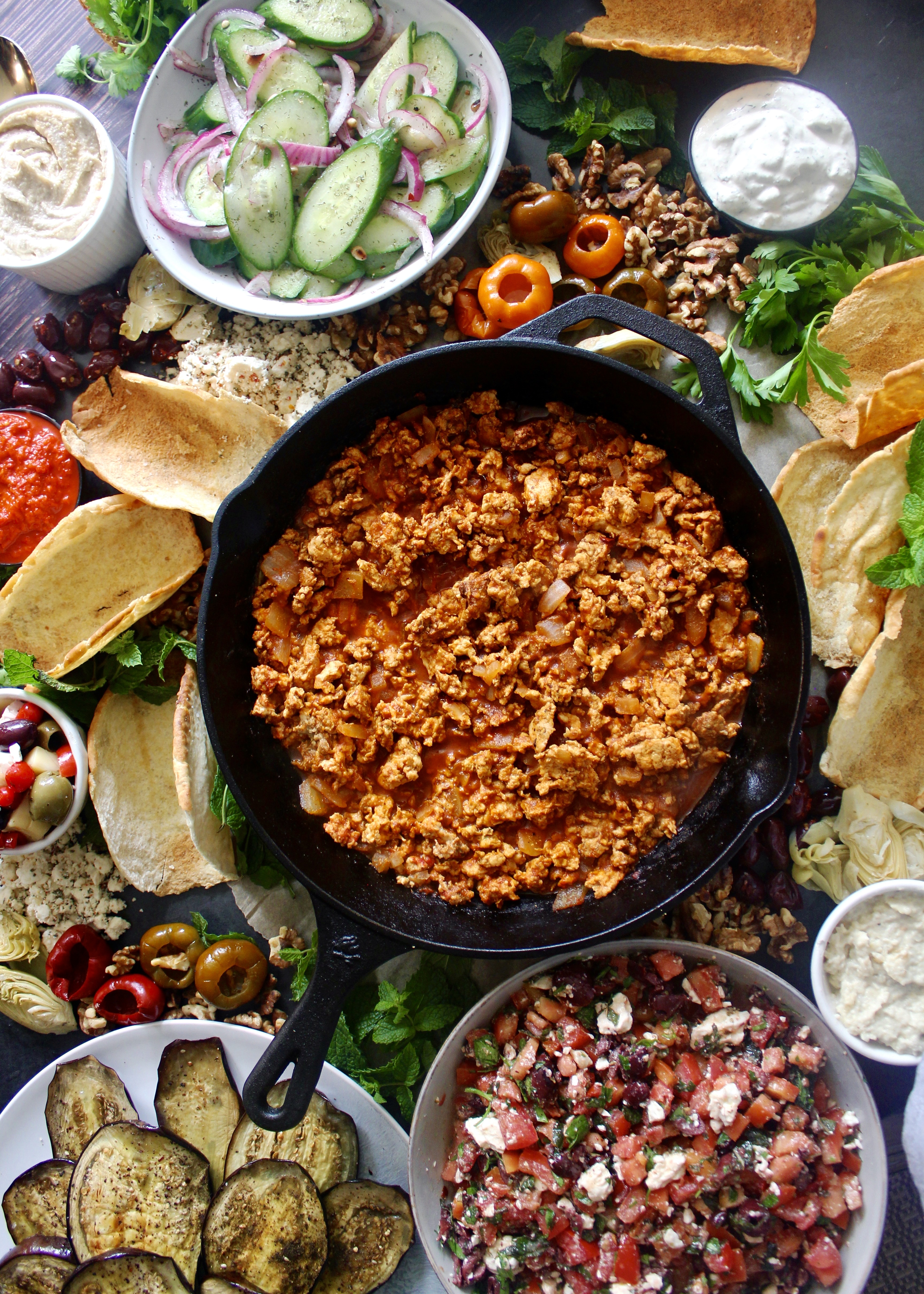 Crispy homemade pita shells, saucy spiced lamb, and an assortment of toppings of your choosing: this Mezze Board Spiced Lamb Taco Bar is the ultimate party spread.