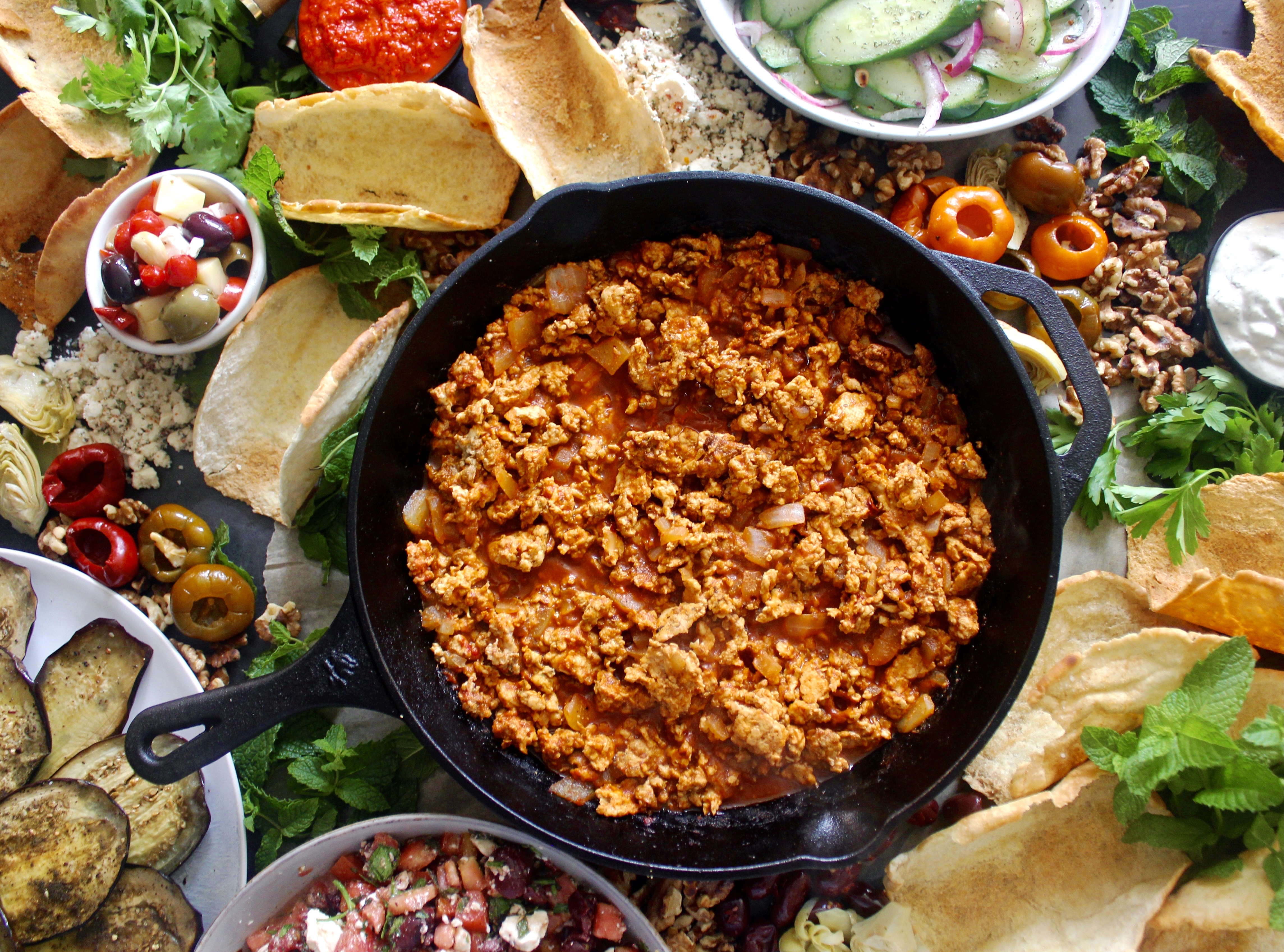 Crispy homemade pita shells, saucy spiced lamb, and an assortment of toppings of your choosing: this Mezze Board Spiced Lamb Taco Bar is the ultimate party spread.