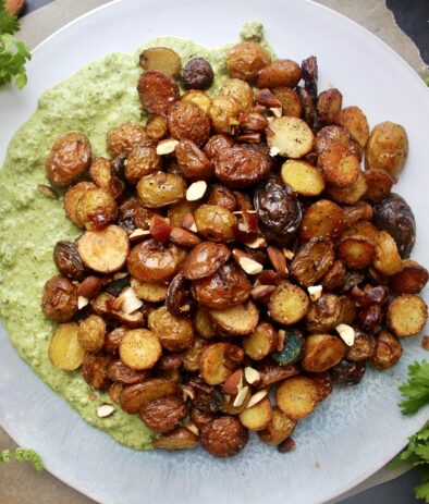 Vibrant, fresh cilantro and mint chutney layered with crunchy baby potatoes and all the textures: these Green Chutney Crispy Potatoes are the most flavorful side!