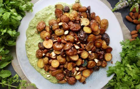 Vibrant, fresh cilantro and mint chutney layered with crunchy baby potatoes and all the textures: these Green Chutney Crispy Potatoes are the most flavorful side!