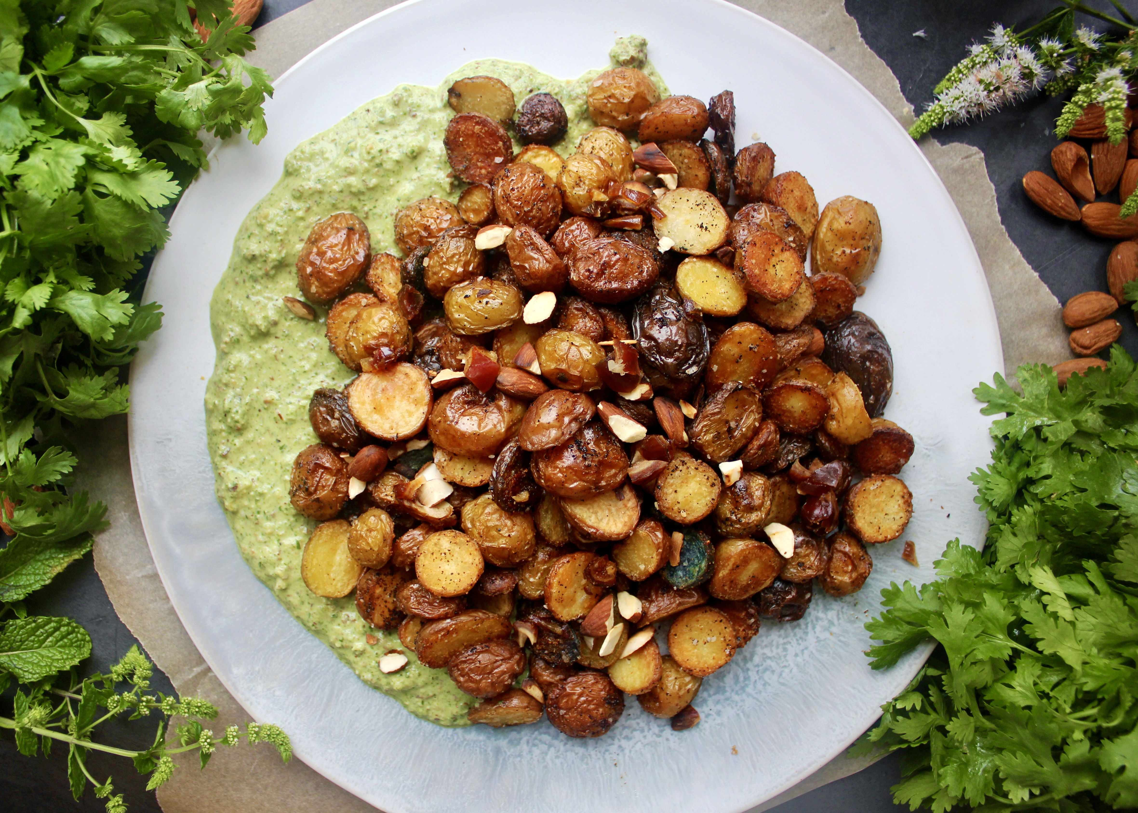 Vibrant, fresh cilantro and mint chutney layered with crunchy baby potatoes and all the textures: these Green Chutney Crispy Potatoes are the most flavorful side!