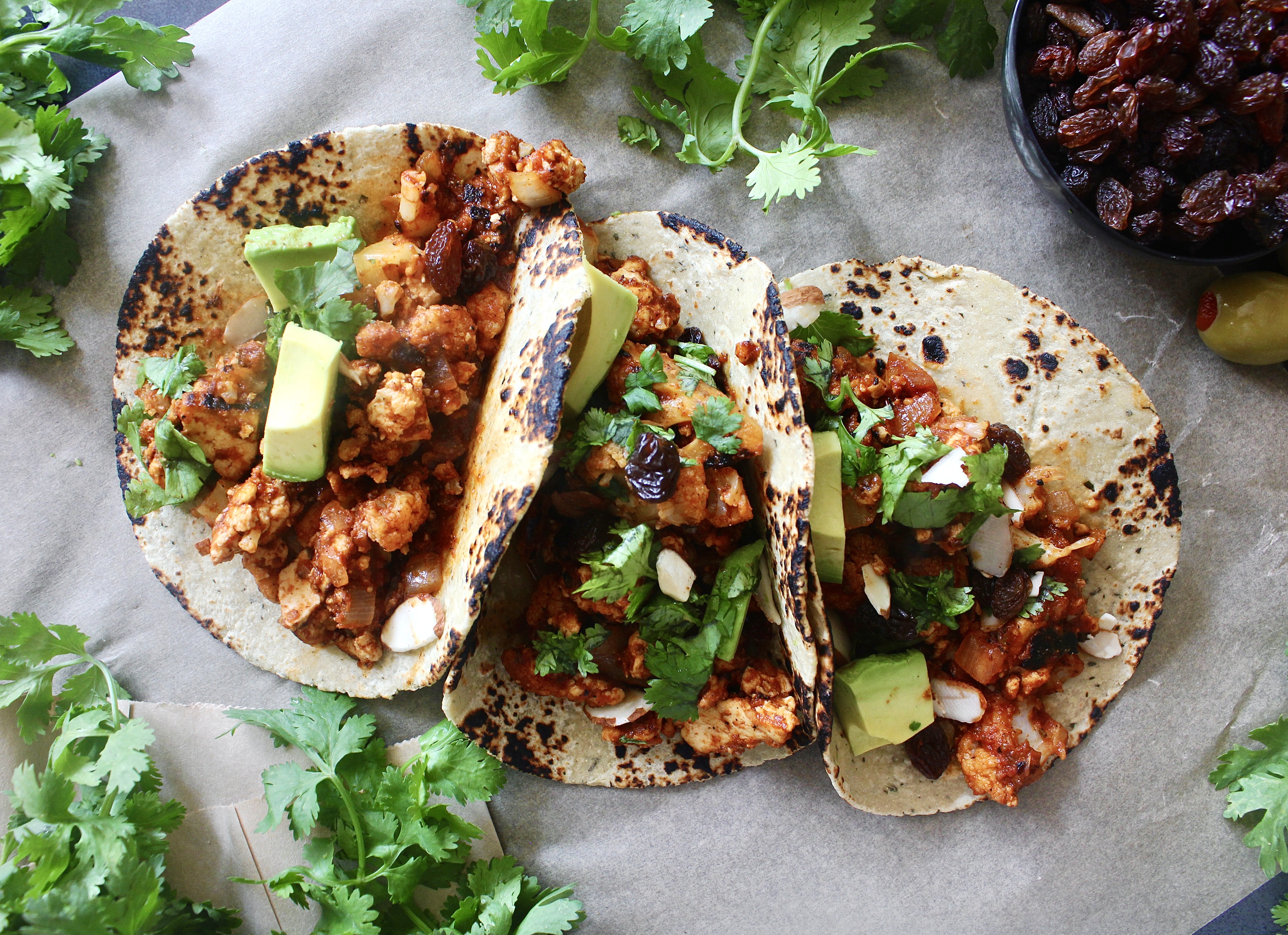 Sweet, spicy, tangy, and salty: these Saucy Cuban Picadillo Tofu and Cauliflower Tacos are stuffed to the brim with the best vegetarian take on the classic dish!