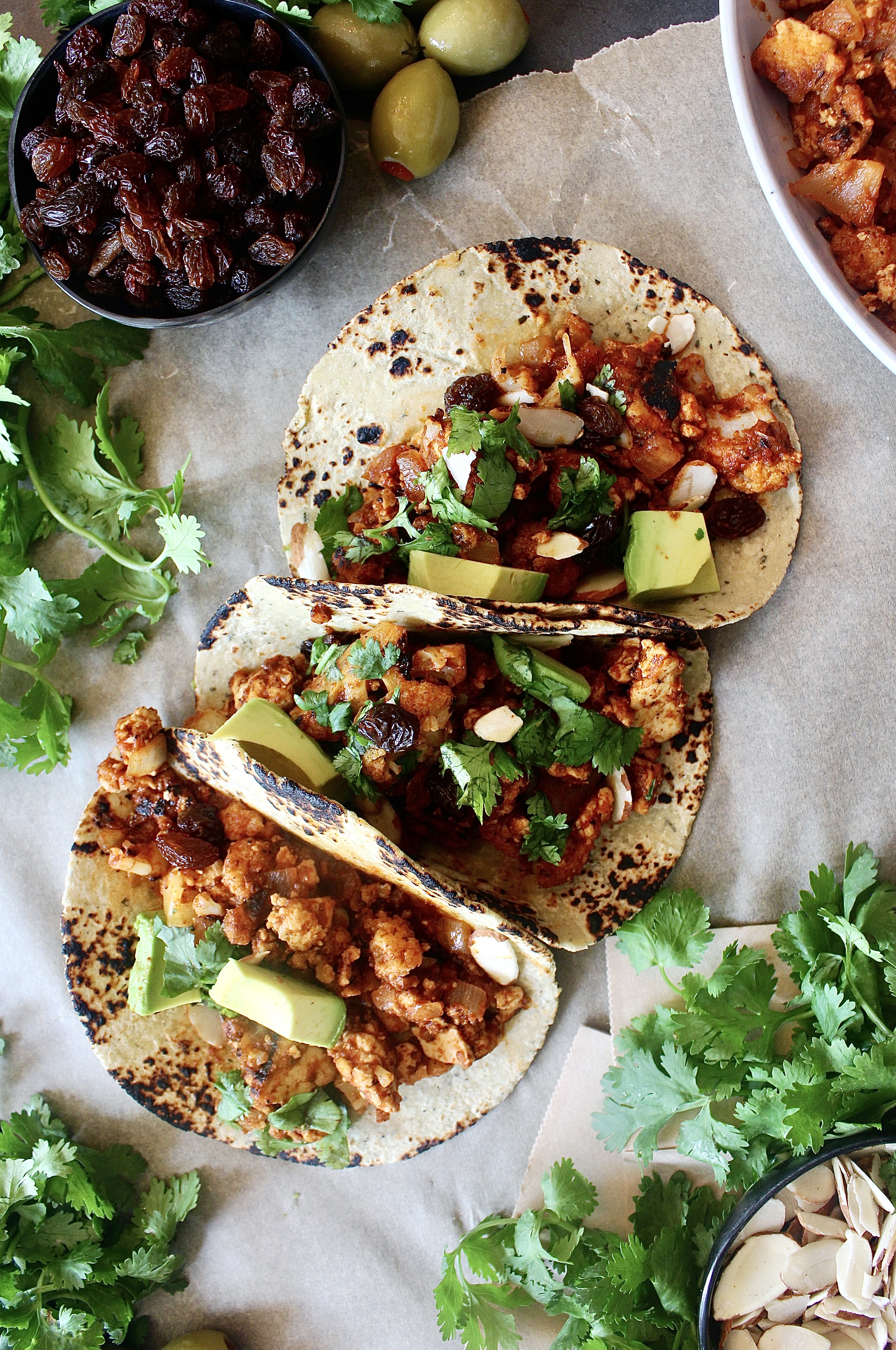 Sweet, spicy, tangy, and salty: these Saucy Cuban Picadillo Tofu and Cauliflower Tacos are stuffed to the brim with the best vegetarian take on the classic dish!