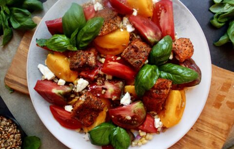 Crispy, spiced bite sized salmon tossed a simply dressed heirloom tomatoes, corn, and farro salad: this Blackened Salmon Bite Summer Farro Salad is a weekly staple this time of year!!