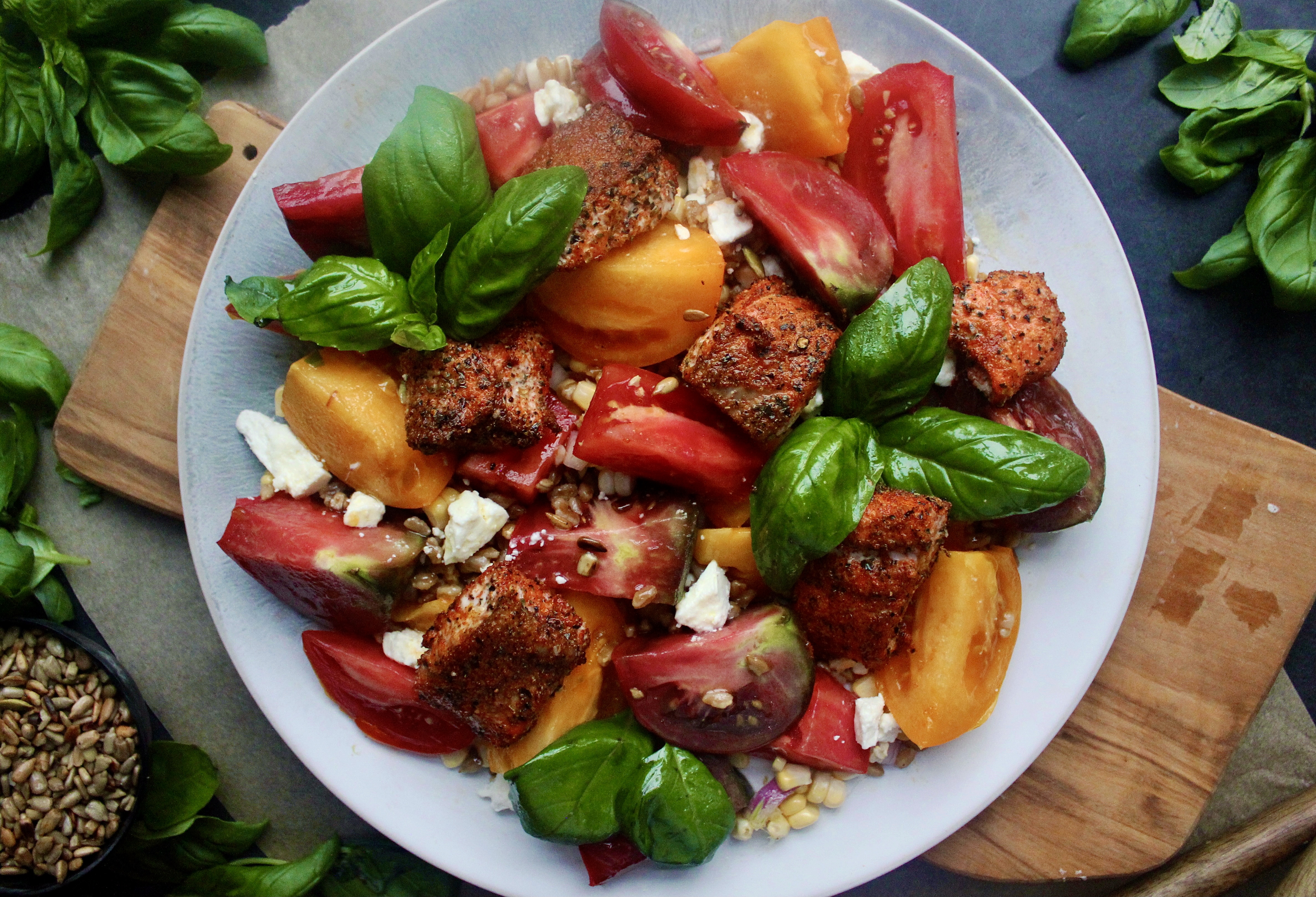 Crispy, spiced bite sized salmon tossed a simply dressed heirloom tomatoes, corn, and farro salad: this Blackened Salmon Bite Summer Farro Salad is a weekly staple this time of year!!