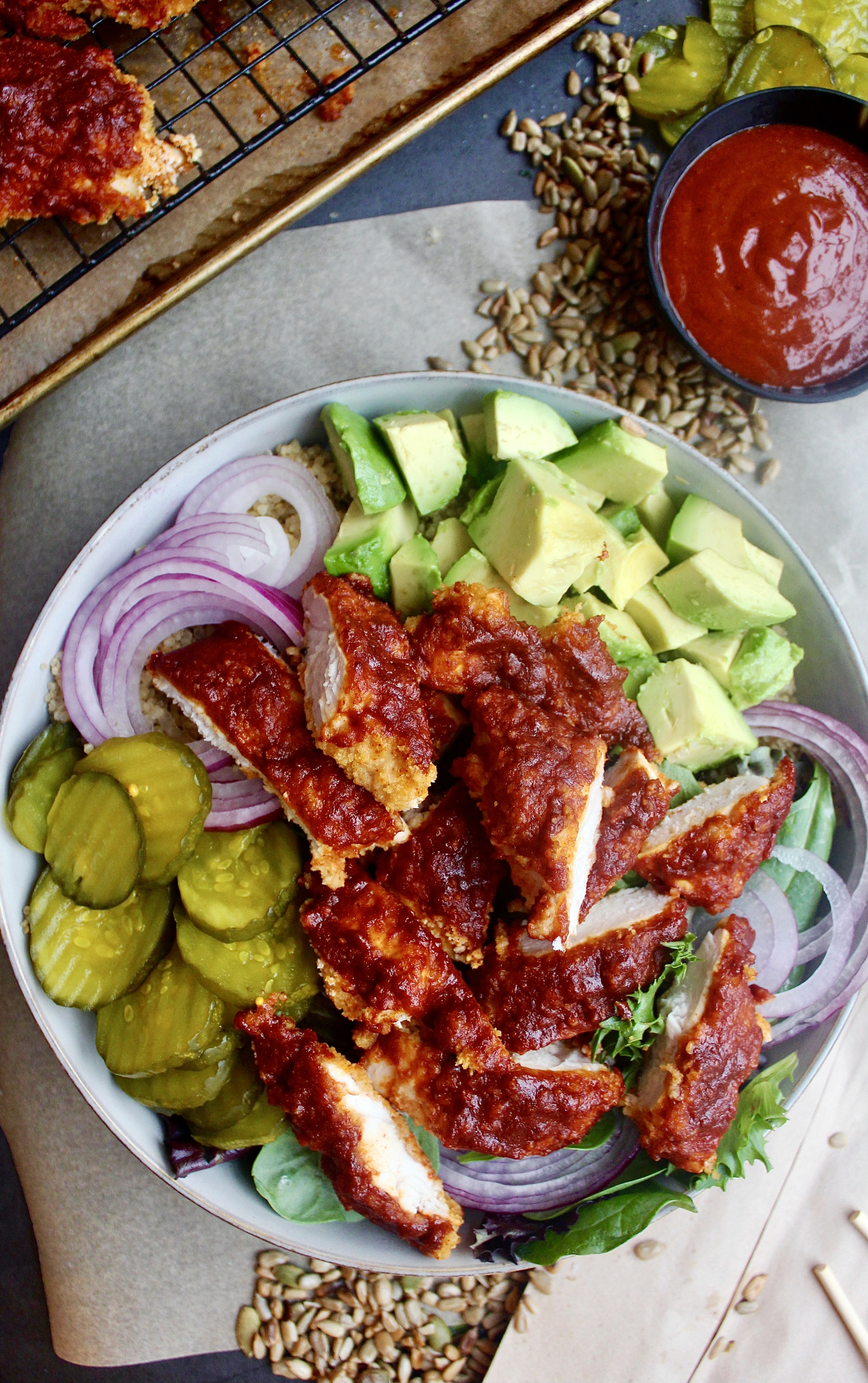 A lighter take on the classic crispy southern chicken all chopped up in a bowl with your fav sweet and spicy  toppings: these Healthier Nashville Hot Chicken Bowls are my everything!!