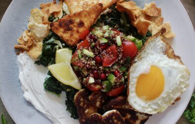 A creamy layer of lemony labneh, white wine garlicky wilted kale, and a few spoonfuls of a pomegranate quinoa salad all finished off with crispy cheese and a fried egg: these Loaded Lebanese Kale, Quinoa Salad, and Fried Egg Plates are seriously next-level amazing.