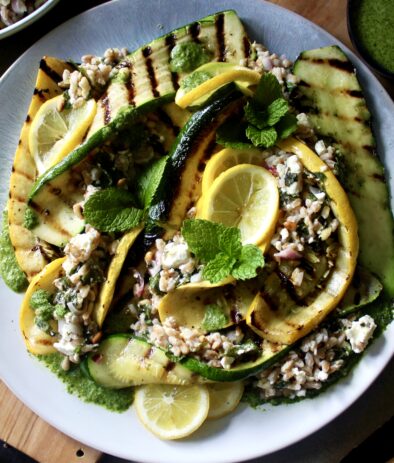 Crispy toasted farro tossed with zesty lemon, fresh mint, and creamy feta topped over charred summer squash and finished with a drizzle of mint vinaigrette: this Grilled Summer Squash Mint and Toasted Farro Salad is truly the summer salad of your dreams.