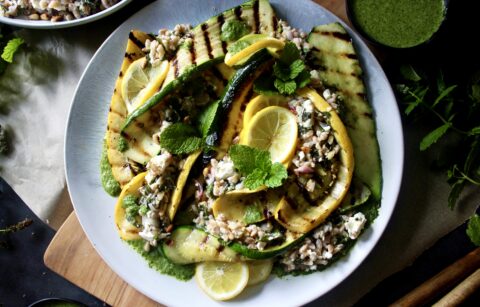 Crispy toasted farro tossed with zesty lemon, fresh mint, and creamy feta topped over charred summer squash and finished with a drizzle of mint vinaigrette: this Grilled Summer Squash Mint and Toasted Farro Salad is truly the summer salad of your dreams.