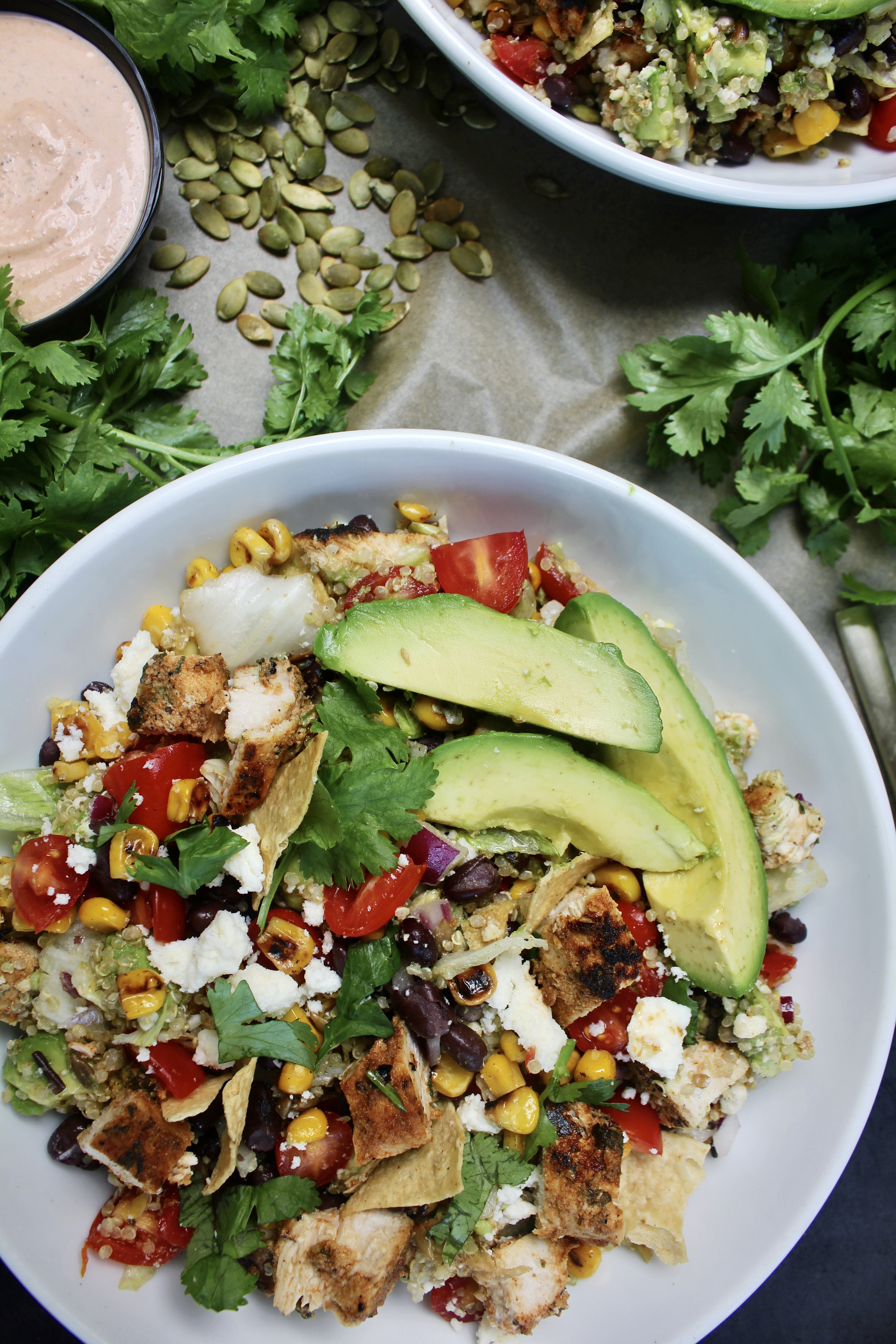 Juicy caramelized chicken, all the good crispy crunchy bits, creamy avocado and cotija, and a citrus vinaigrette all finished off with a cooling spicy yogurt crema: this Everyday Southwest Chicken Quinoa Salad with Spicy Crema is a game-changing meal. 