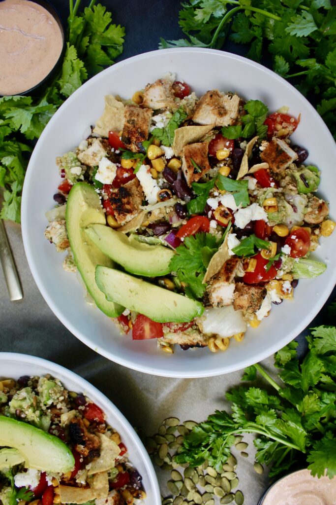 Juicy caramelized chicken, all the good crispy crunchy bits, creamy avocado and cotija, and a citrus vinaigrette all finished off with a cooling spicy yogurt crema: this Everyday Southwest Chicken Quinoa Salad with Spicy Crema is a game-changing meal. 