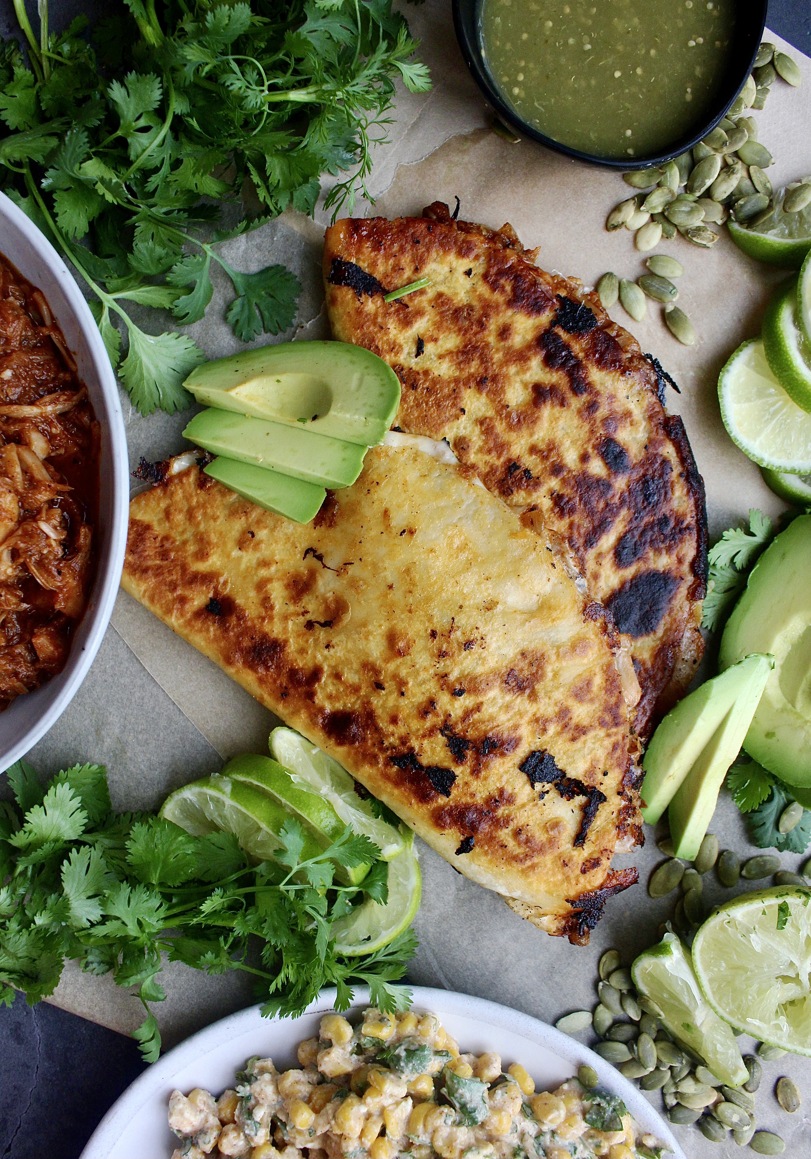 Smoky, juicy pulled jackfruit carnitas tucked into a cheesy tortilla served with avocado and my Super Simple Mexican Corn Dip: these Jackfruit Carnitas Quesadillas with Mexican Corn Dip are the ultimate healthy vegetarian munchie.