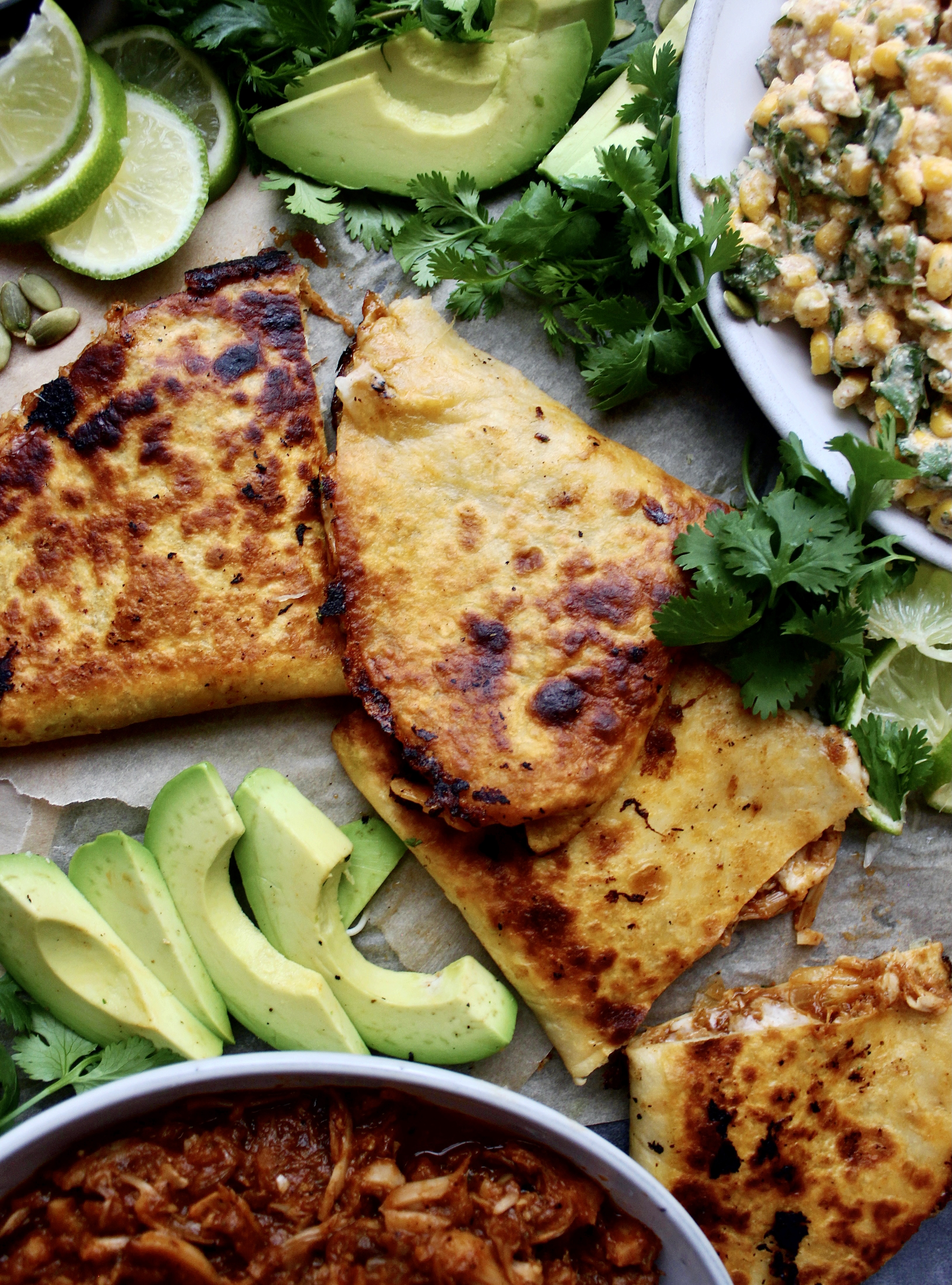 Smoky, juicy pulled jackfruit carnitas tucked into a cheesy tortilla served with avocado and my Super Simple Mexican Corn Dip: these Jackfruit Carnitas Quesadillas with Mexican Corn Dip are the ultimate healthy vegetarian munchie.