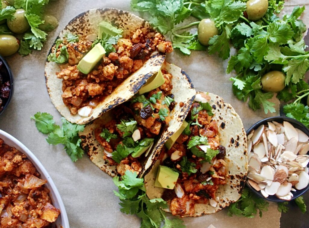 Sweet, spicy, tangy, and salty: these Saucy Cuban Picadillo Tofu and Cauliflower Tacos are stuffed to the brim with the best vegetarian take on the classic dish!