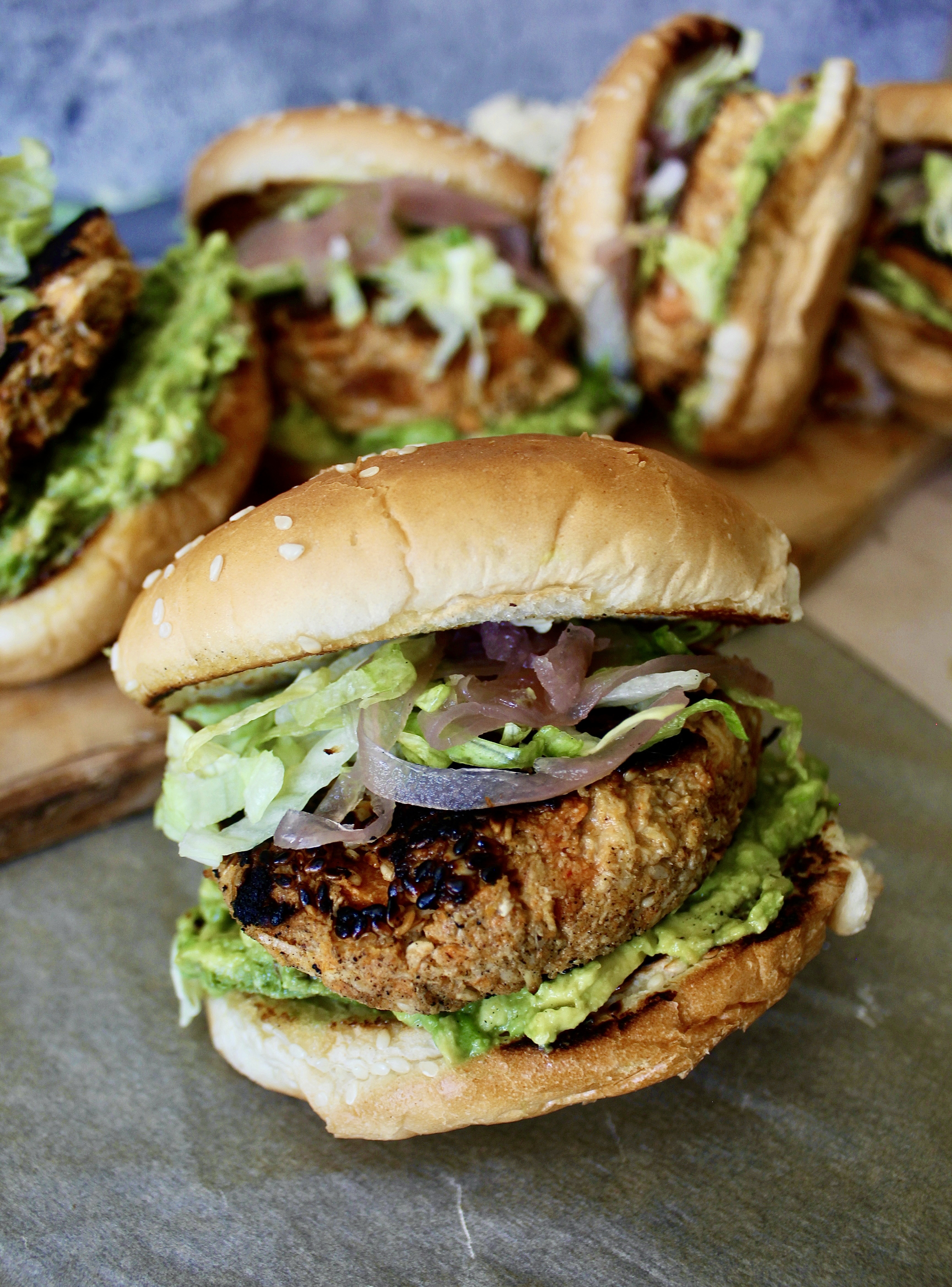 Juicy pulled chicken folded in with warming spices, sweet potato, and tahini topped off with avocado and pickled onions: these Sweet Potato Pulled Chicken Tahini Burgers are an all time fav!!