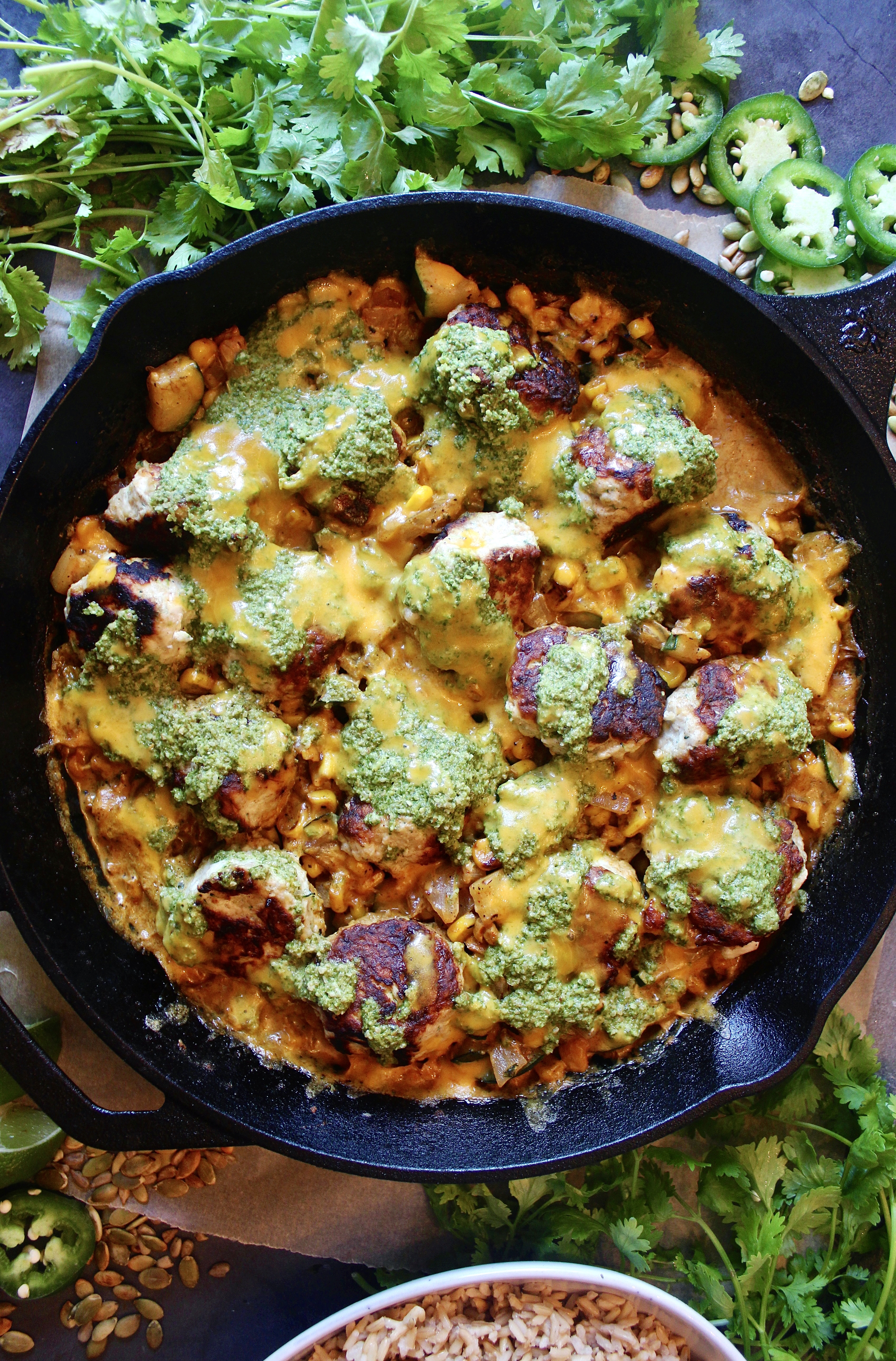 Crispy, juicy chicken meatballs in a cheesy creamy corn skillet all baked under a tangy cilantro jalapeño chutney: this Creamy Jalapeño Cheddar Chicken Meatball Skillet is the healthy comfort food we all need in our lives. 