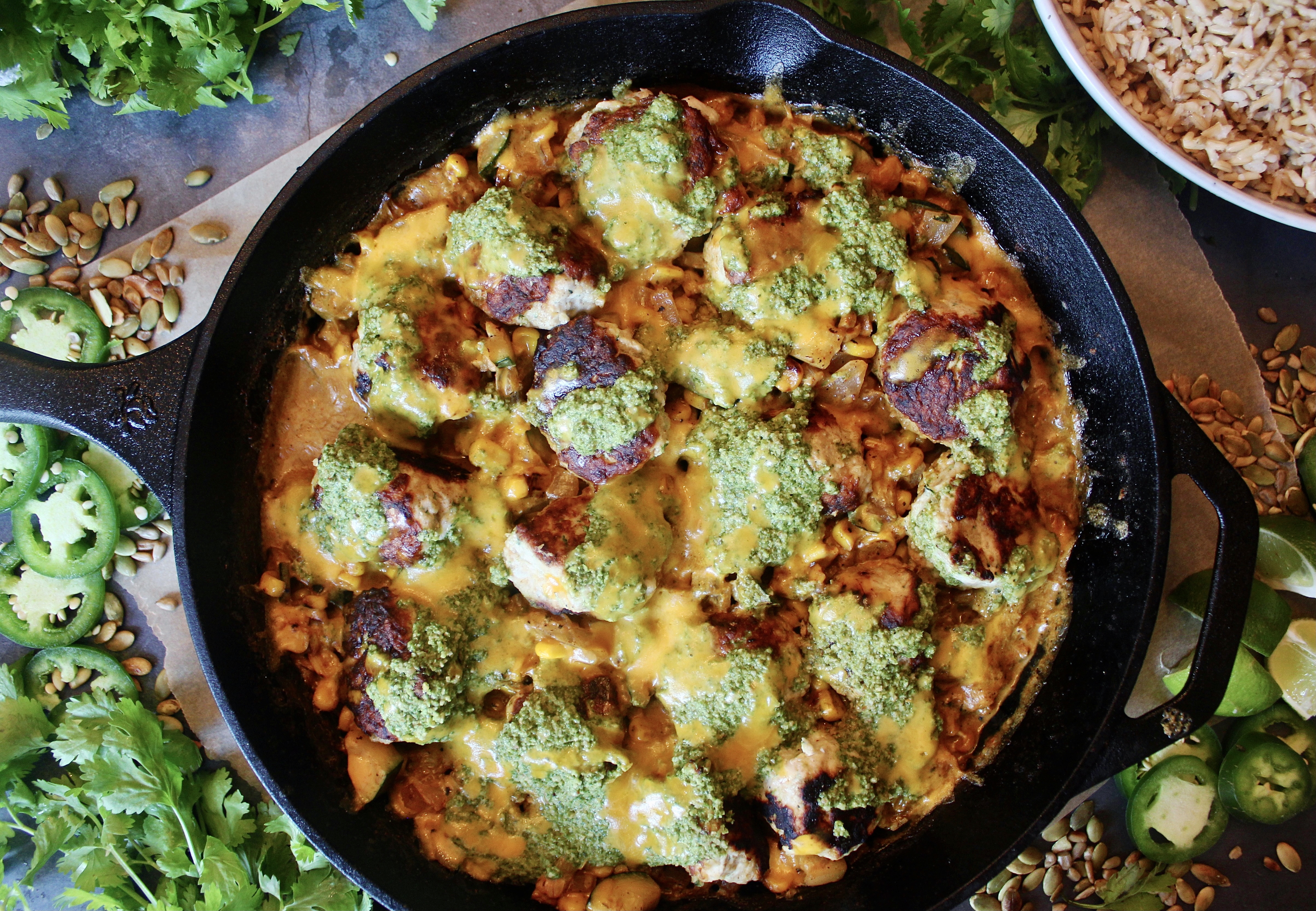 Crispy, juicy chicken meatballs in a cheesy creamy corn skillet all baked under a tangy cilantro jalapeño chutney: this Creamy Jalapeño Cheddar Chicken Meatball Skillet is the healthy comfort food we all need in our lives.