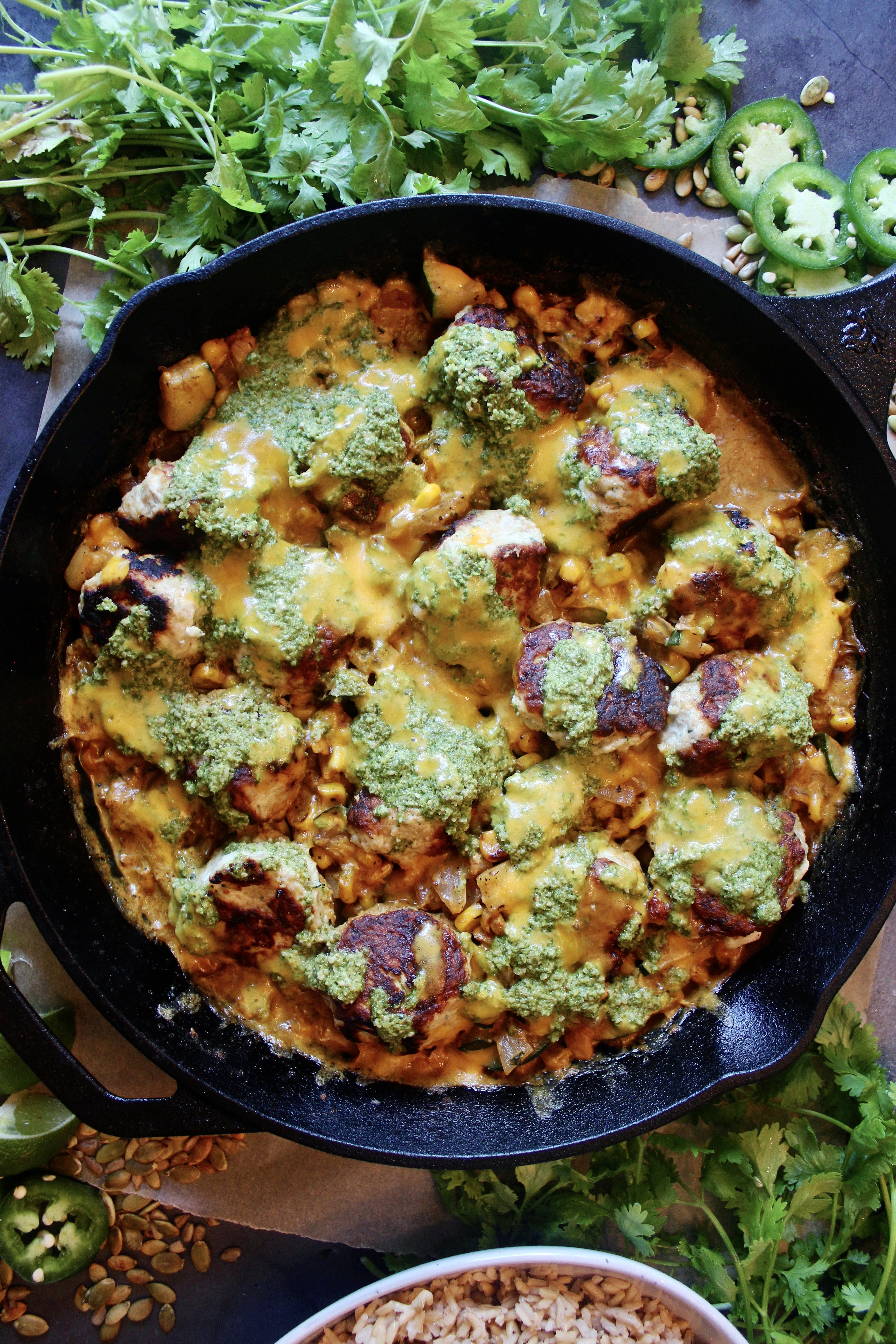 Crispy, juicy chicken meatballs in a cheesy creamy corn skillet all baked under a tangy cilantro jalapeño chutney: this Creamy Jalapeño Cheddar Chicken Meatball Skillet is the healthy comfort food we all need in our lives. 