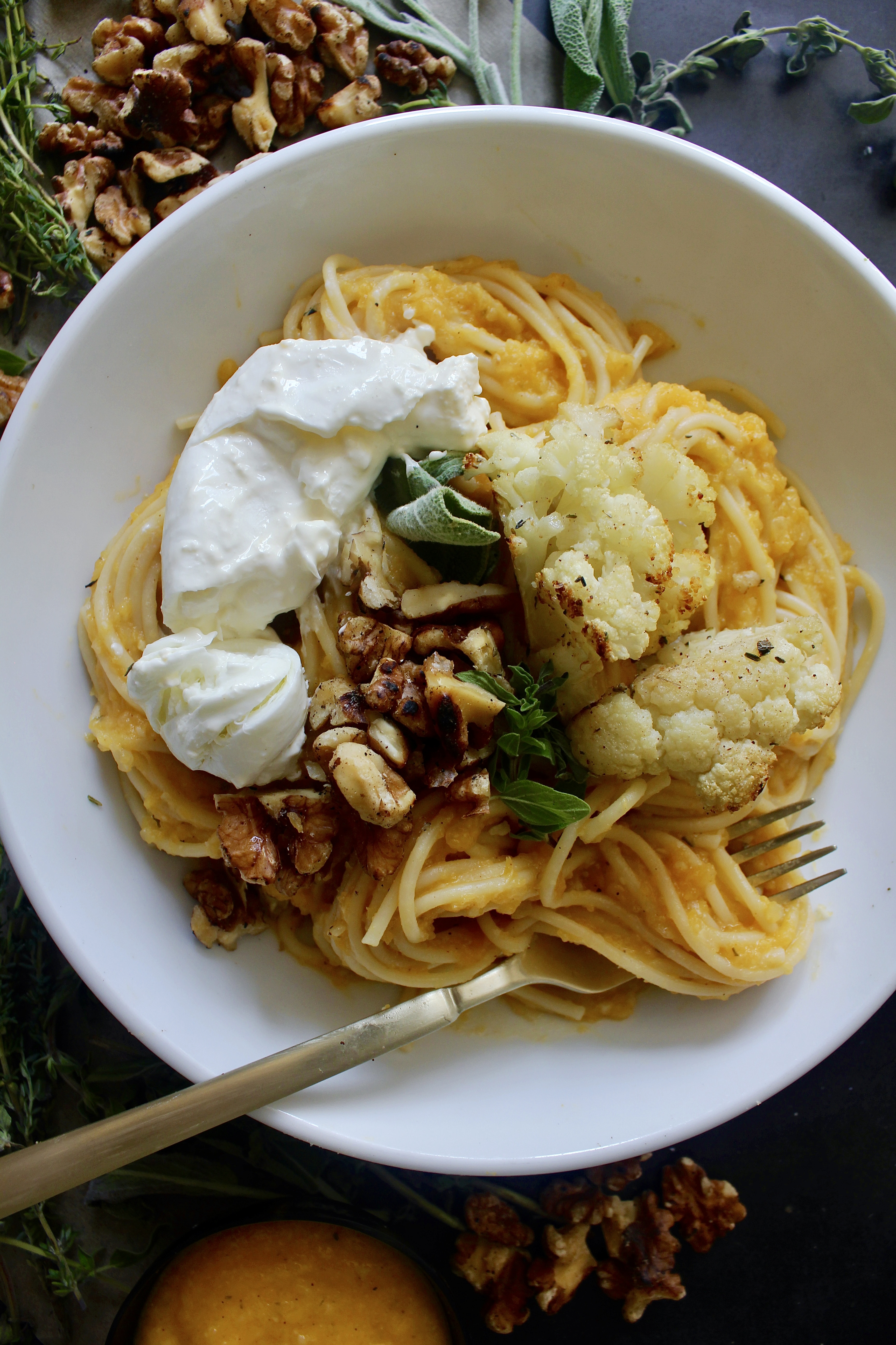 A perfectly roasted caramelized butternut squash sauce with tons of garlic, all the seasonings, and plenty of parmesan cheese all tossed with spaghetti and topped off with crispy cauliflower, creamy burrata, and toasted walnuts: this Creamy Herbed Butternut Squash Spaghetti with Cauliflower and Burrata is truly the pasta of your dreams. 