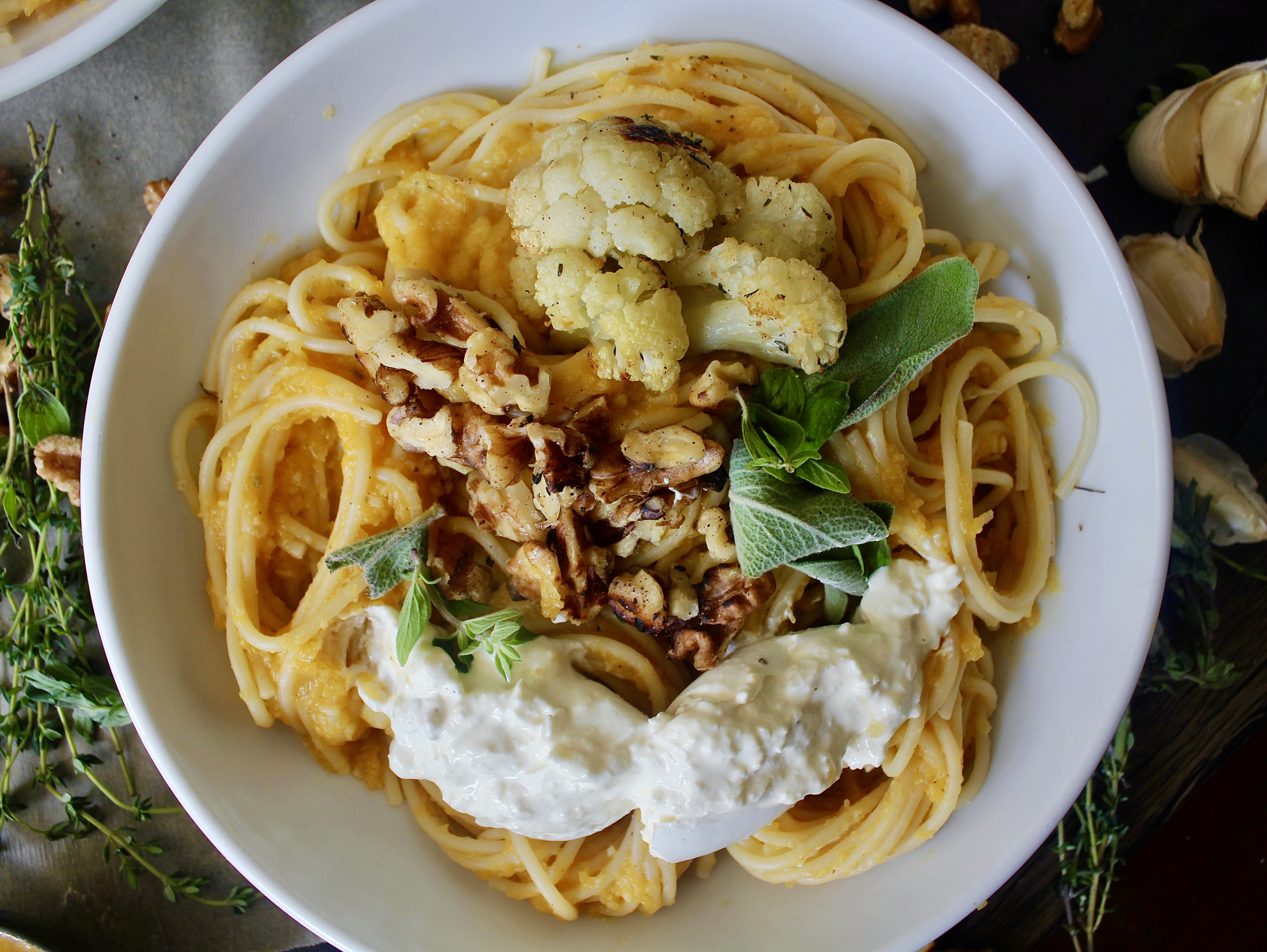 A perfectly roasted caramelized butternut squash sauce with tons of garlic, all the seasonings, and plenty of parmesan cheese all tossed with spaghetti and topped off with crispy cauliflower, creamy burrata, and toasted walnuts: this Creamy Herbed Butternut Squash Spaghetti with Cauliflower and Burrata is truly the pasta of your dreams.
