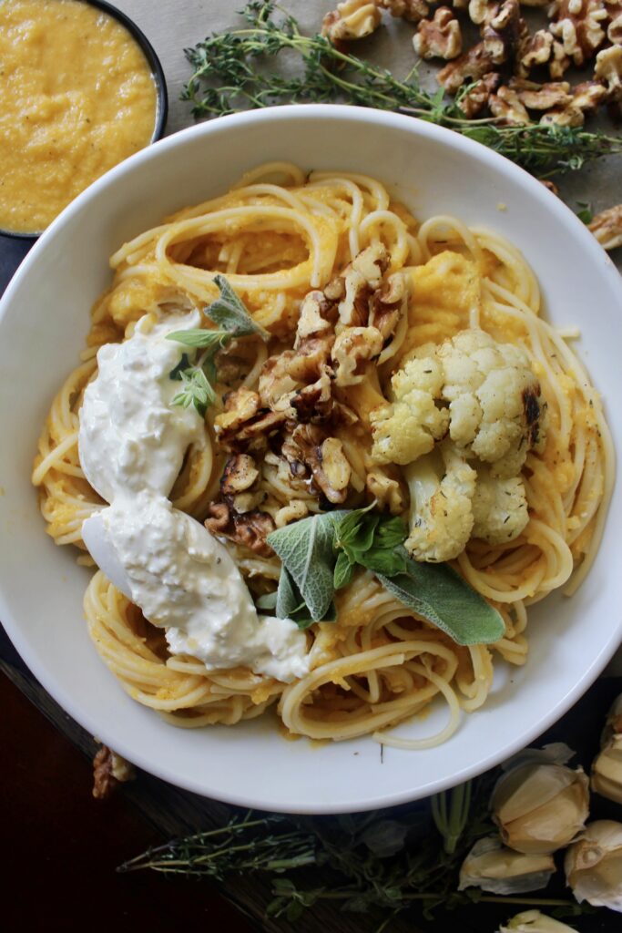A perfectly roasted caramelized butternut squash sauce with tons of garlic, all the seasonings, and plenty of parmesan cheese all tossed with spaghetti and topped off with crispy cauliflower, creamy burrata, and toasted walnuts: this Creamy Herbed Butternut Squash Spaghetti with Cauliflower and Burrata is truly the pasta of your dreams. 