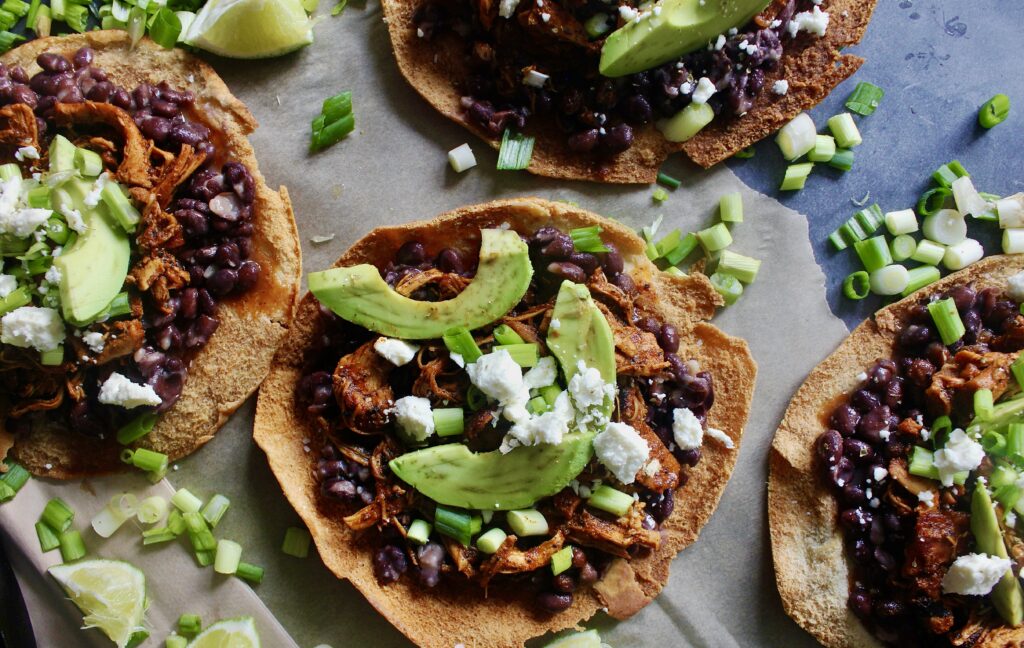 Chicken, Bean, Avocado, and Feta Pita Tostadas