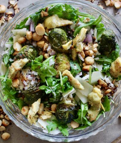 Garlicky charred artichokes and brussels with fresh arugula, parm, and all the crispy crunchy bits tossd in a maple dijon vinaigrette: this Maple Dijon Crispy Artichoke and Brussels Sprouts Salad is the best way to get in those autumn veggies!