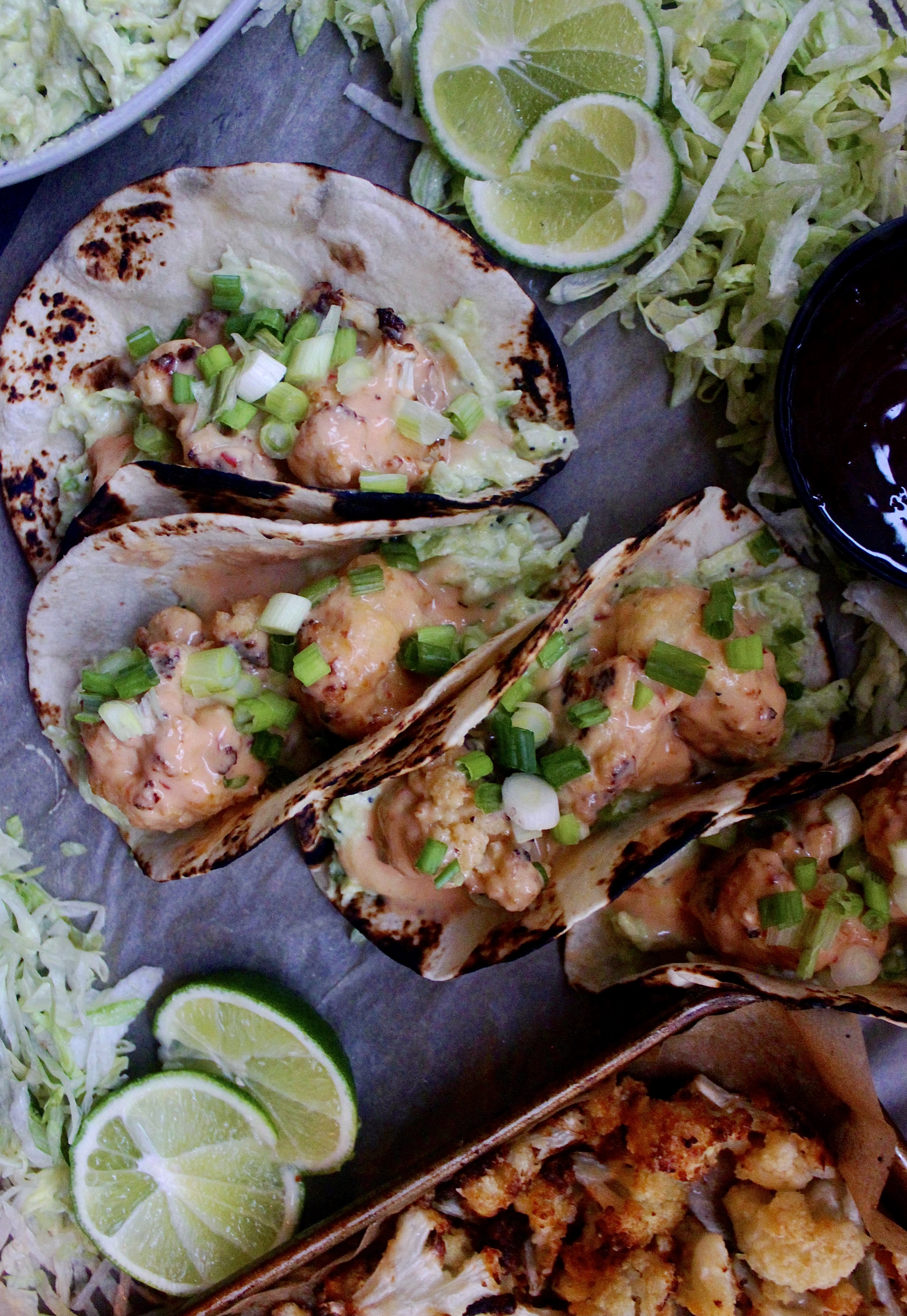 Super crispy, addictively creamy, and a touch bit spicy: there’s seriously nothing better than these Healthier Bang Bang Cauliflower Tacos with Avocado Salad!