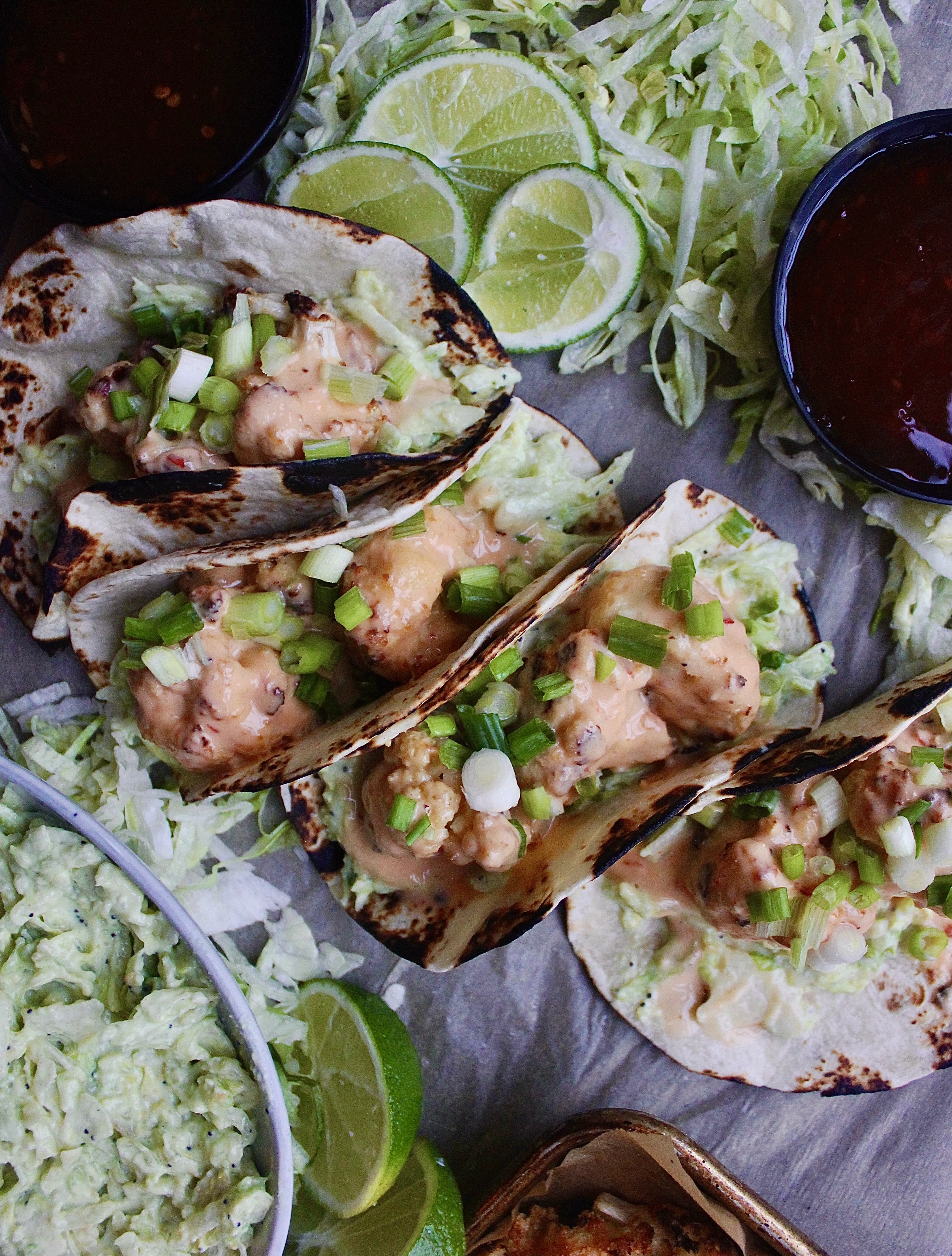 Super crispy, addictively creamy, and a touch bit spicy: there’s seriously nothing better than these Healthier Bang Bang Cauliflower Tacos with Avocado Salad!