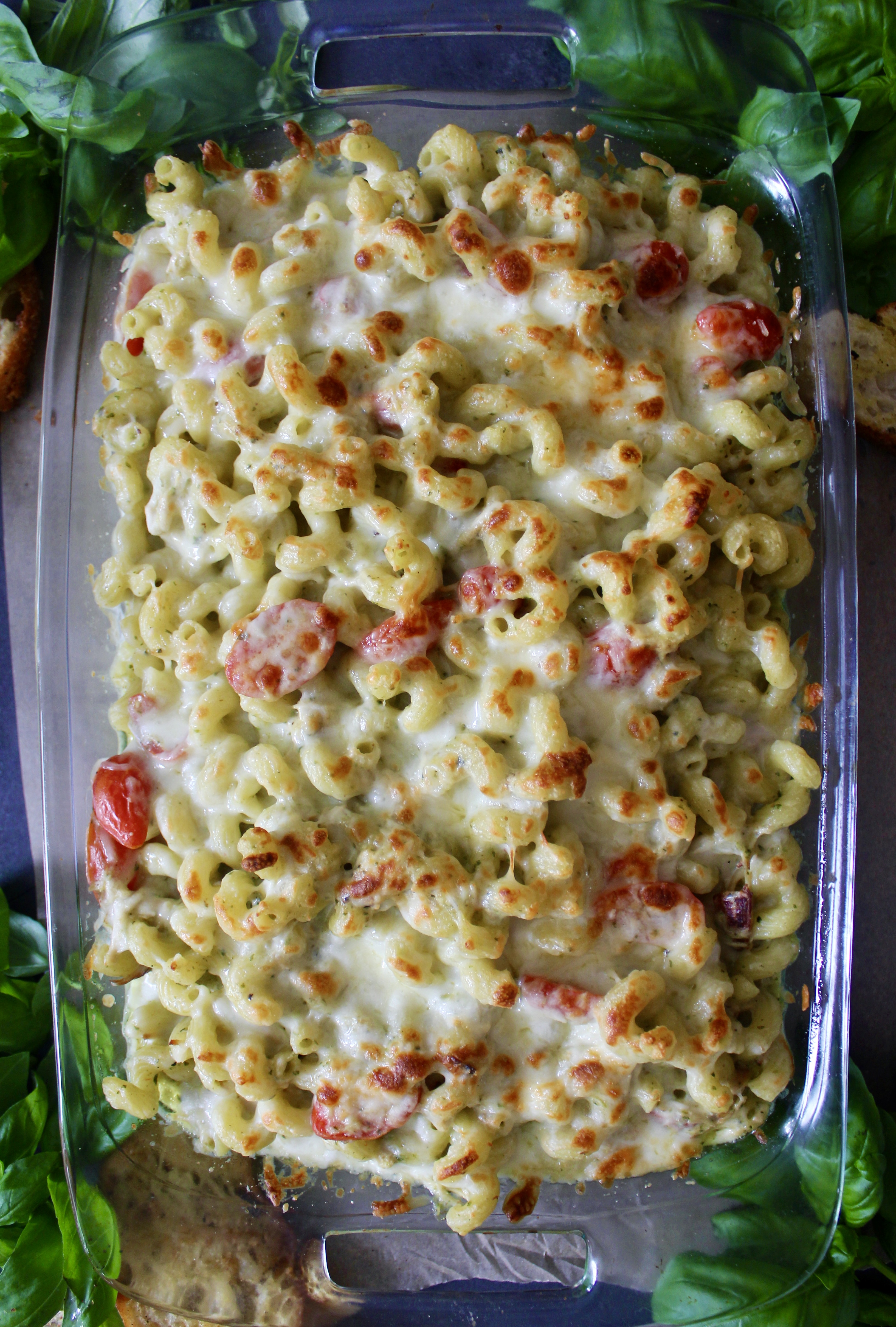 With a base of a creamy pesto cheese sauce, your favorite short cut pasta, and a crispy cheesy top: this Healthier Cheesy Chicken Pesto Pasta Bake is an all time favorite comfort food!