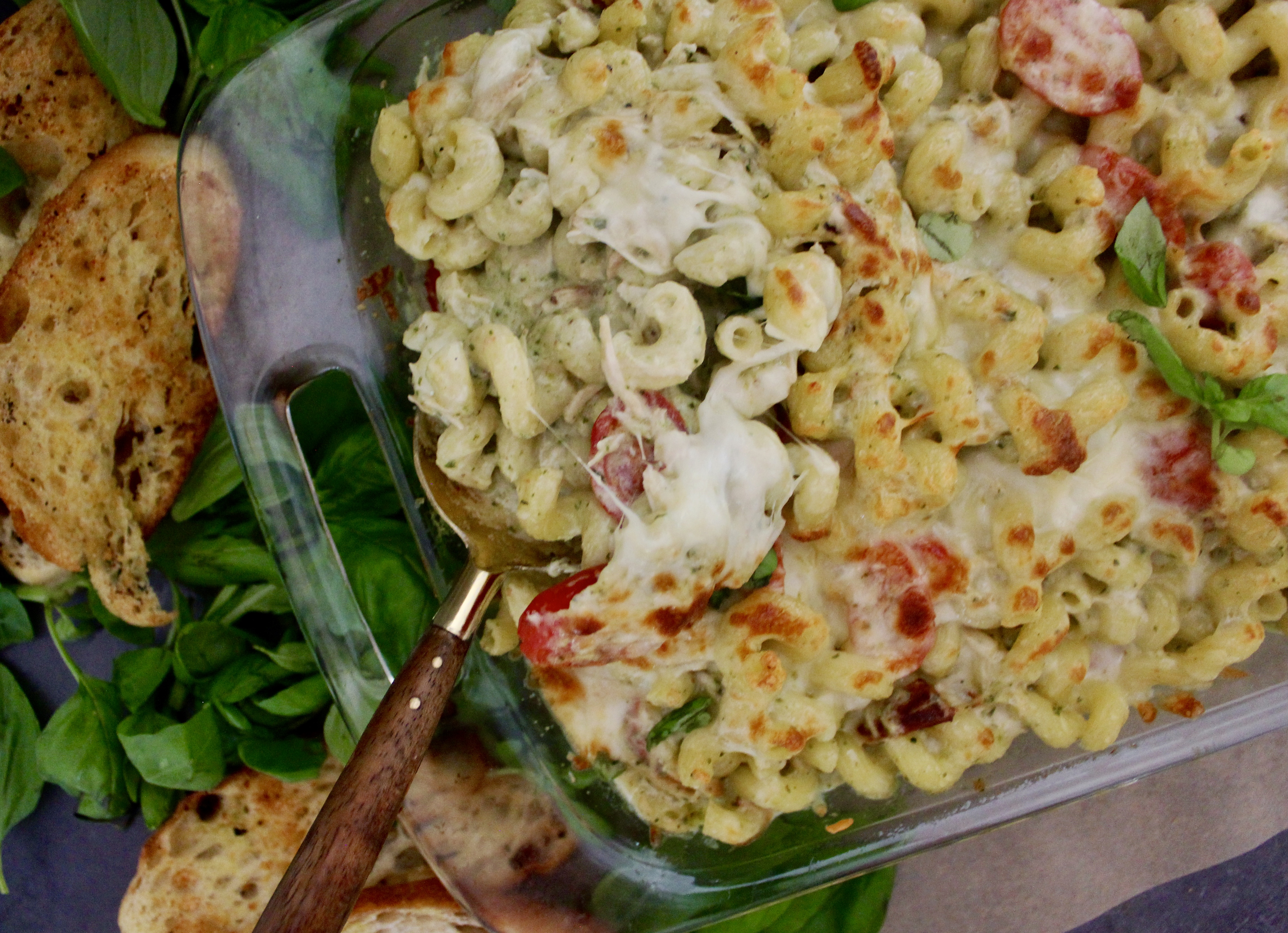 With a base of a creamy pesto cheese sauce, your favorite short cut pasta, and a crispy cheesy top: this Healthier Cheesy Chicken Pesto Pasta Bake is an all time favorite comfort food!