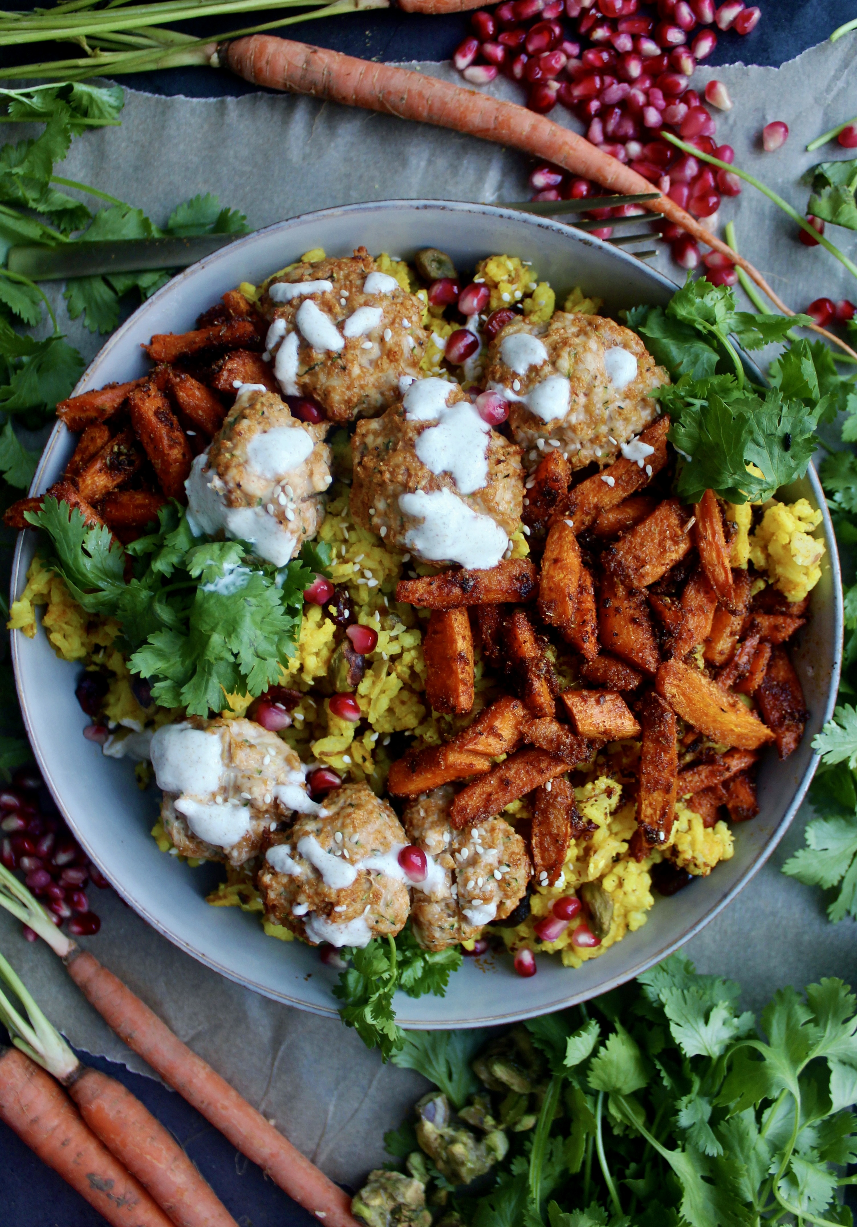 Spiced turmeric saffron rice with super simple Moroccan flavored meatballs topped with a creamy lemon yogurt sauce and tangy pomegranate seeds: these Super Simple Golden Rice and Moroccan Meatball Bowls are the best weeknight dinner!