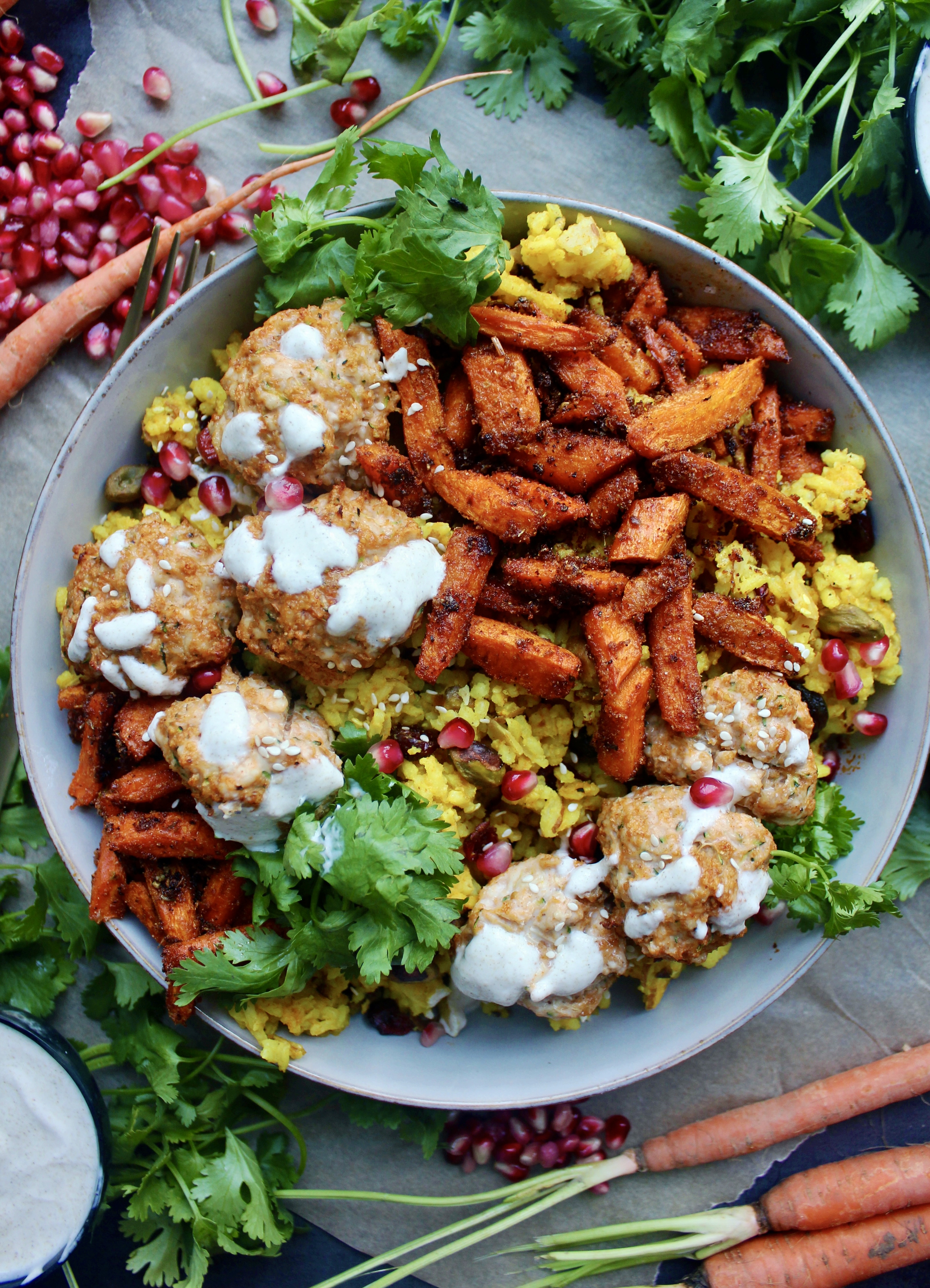 Spiced turmeric saffron rice with super simple Moroccan flavored meatballs topped with a creamy lemon yogurt sauce and tangy pomegranate seeds: these Super Simple Golden Rice and Moroccan Meatball Bowls are the best weeknight dinner!